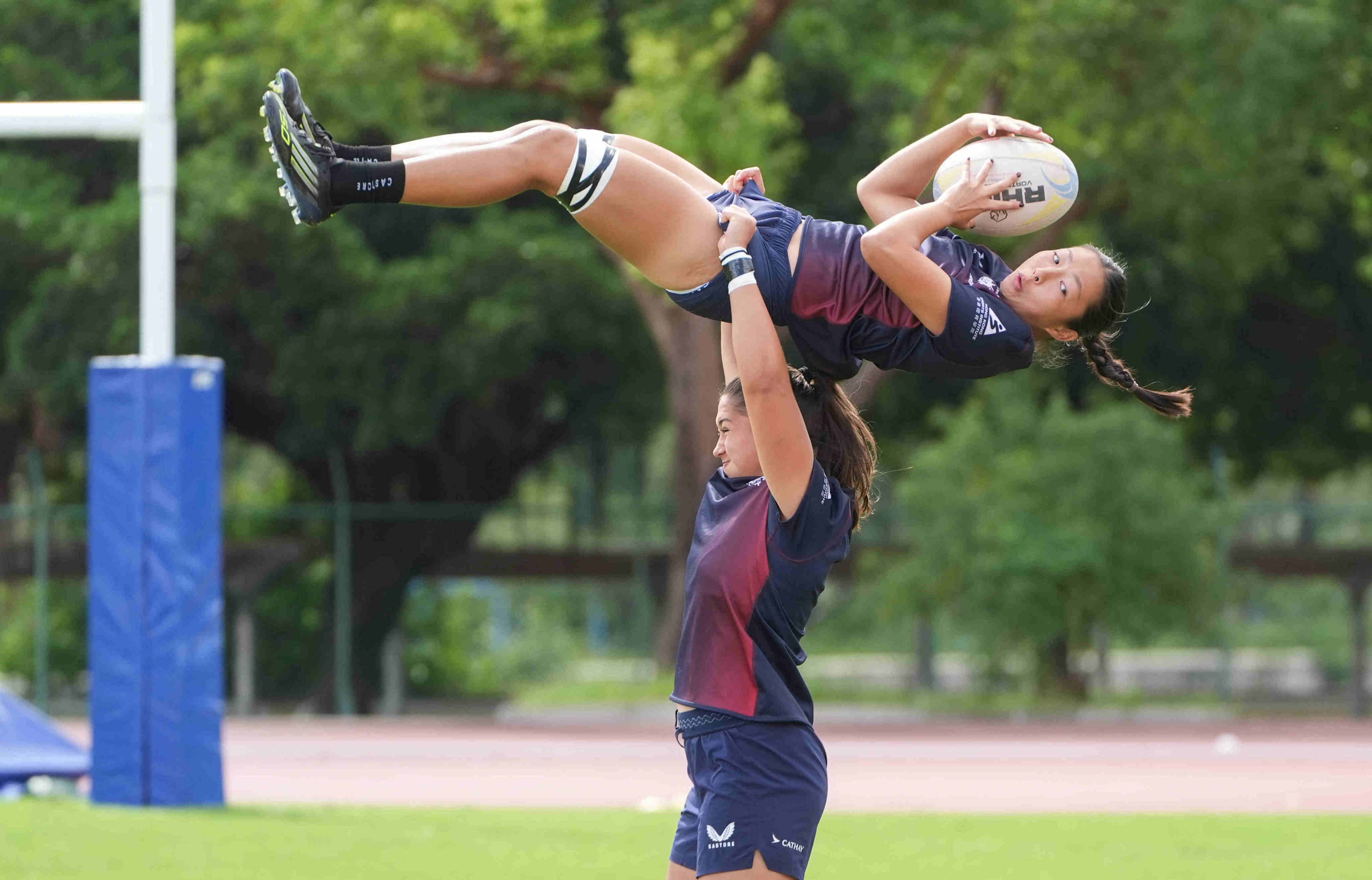 Hong Kong rugby sevens forward Chloe Chan is given a lift by Gabby Rivers during training at Hong Kong Sports Institute. Photo: Eugene Lee