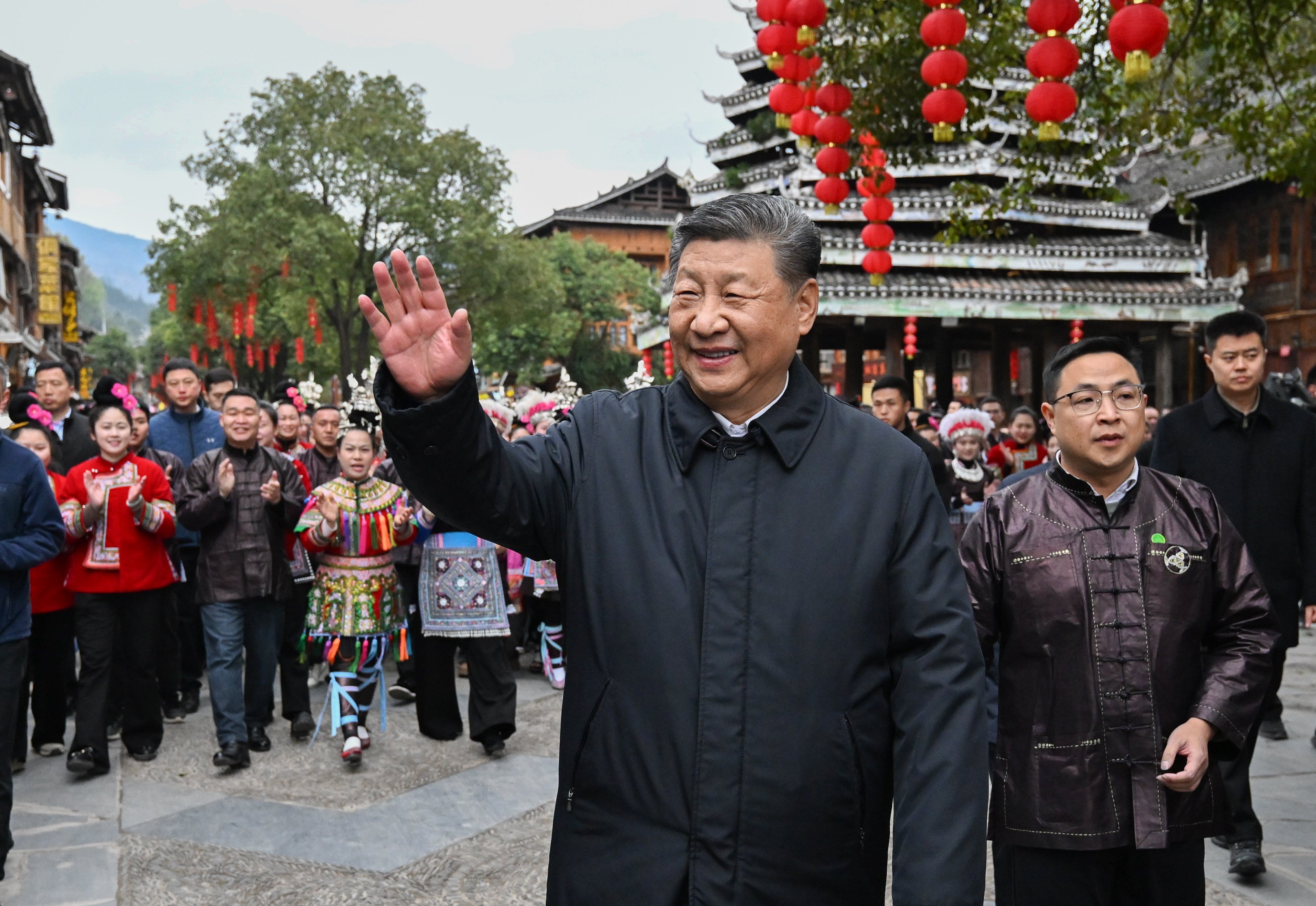 Chinese President Xi Jinping, who also serves as the Communist Party’s general secretary, waves goodbye to villagers while visiting Zhaoxing, Guizhou province, on March 17. Photo: Xinhua