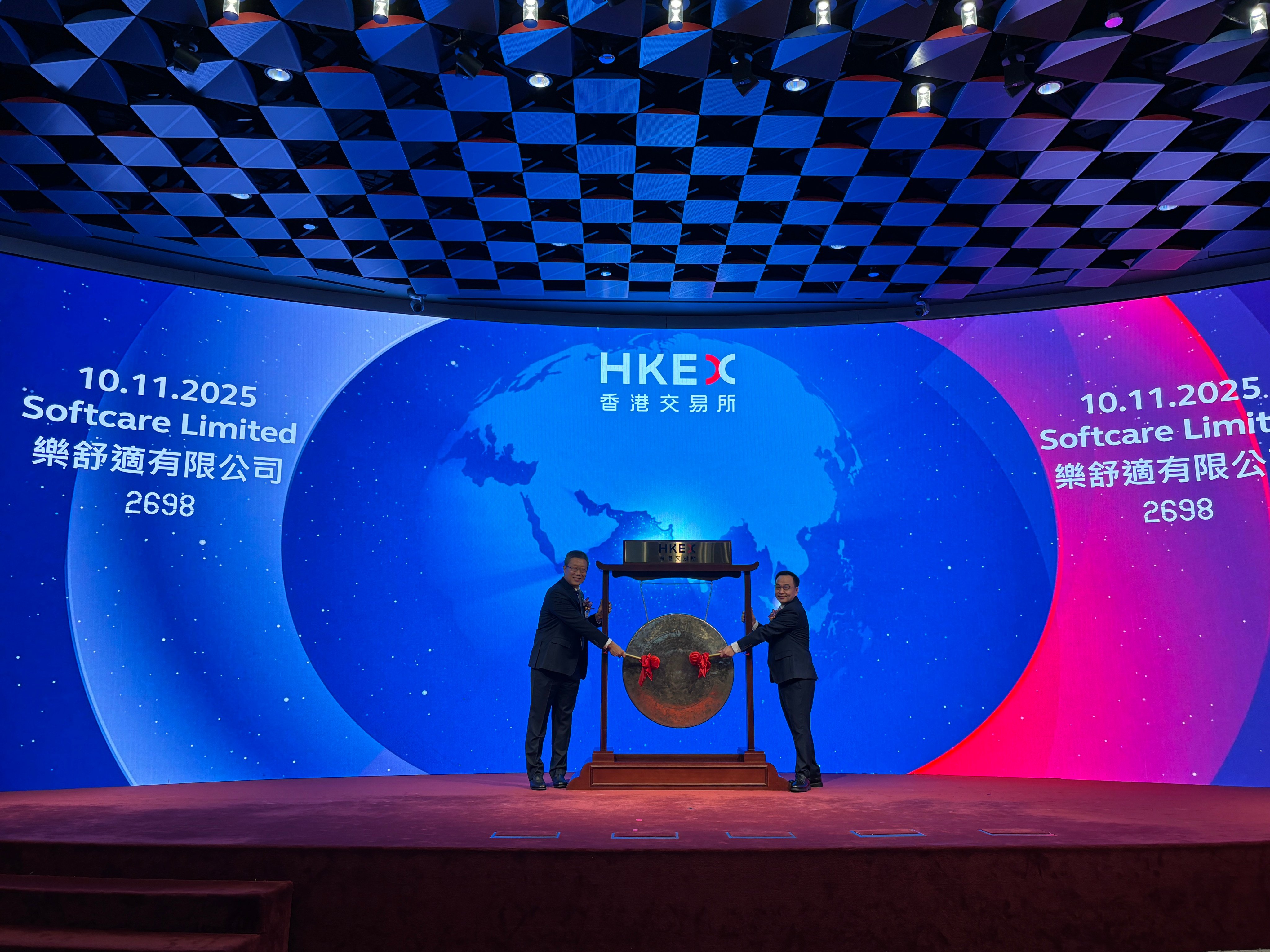 Softcare chairman Shen Yanchang (left) and CEO Luo Jichao strike the gong at the company’s listing ceremony on the Hong Kong stock exchange on Monday. Photo: Yulu Ao