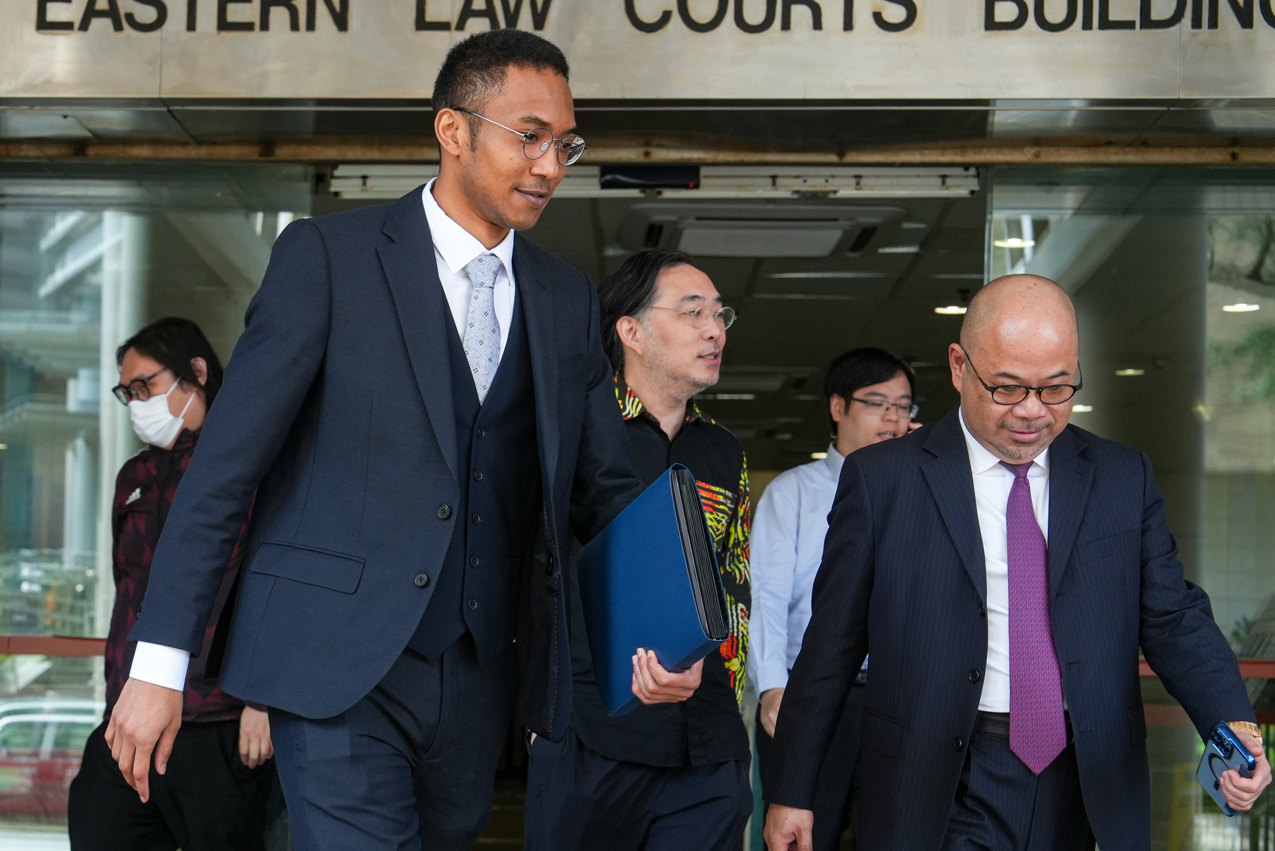 Brian Fok (in waistcoat) leaves Eastern Court in Sai Wan Ho. Photo: Sun Yeung