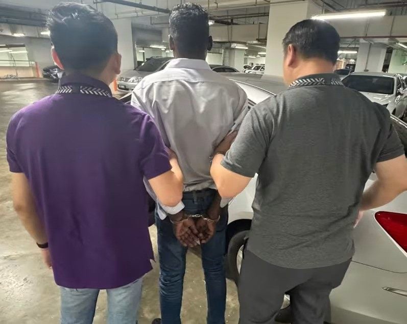 A Malaysian man is arrested on Saturday for allegedly being involved in a government official impersonation scam. Photo: Singapore Police Force