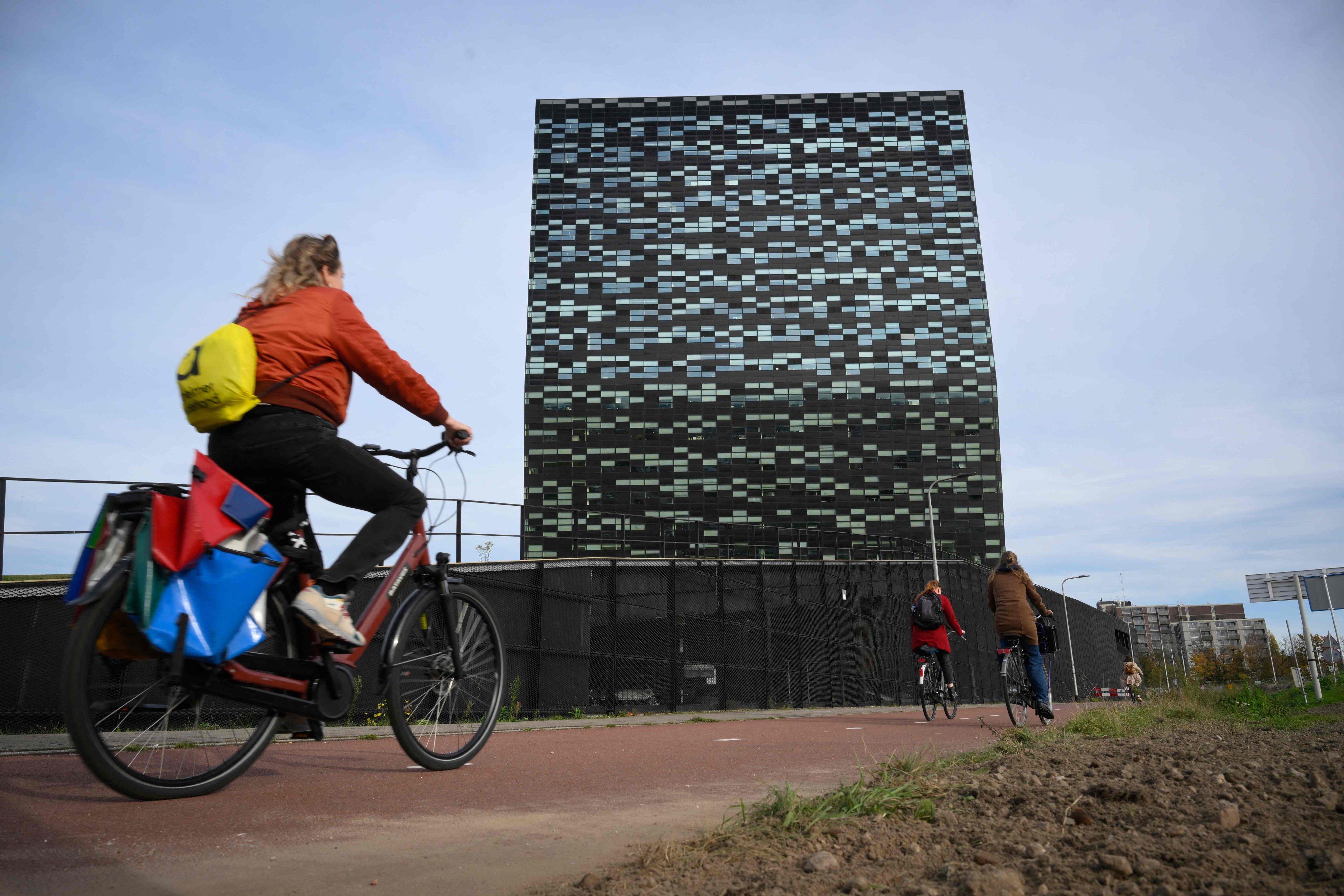 A woman rides past Nexperia headquarters in Nijmegen, the Netherlands. Beijing has granted exemptions to export restrictions on the Dutch chip firm’s products, allowing some chips to flow to Europe once more. Photo: AFP