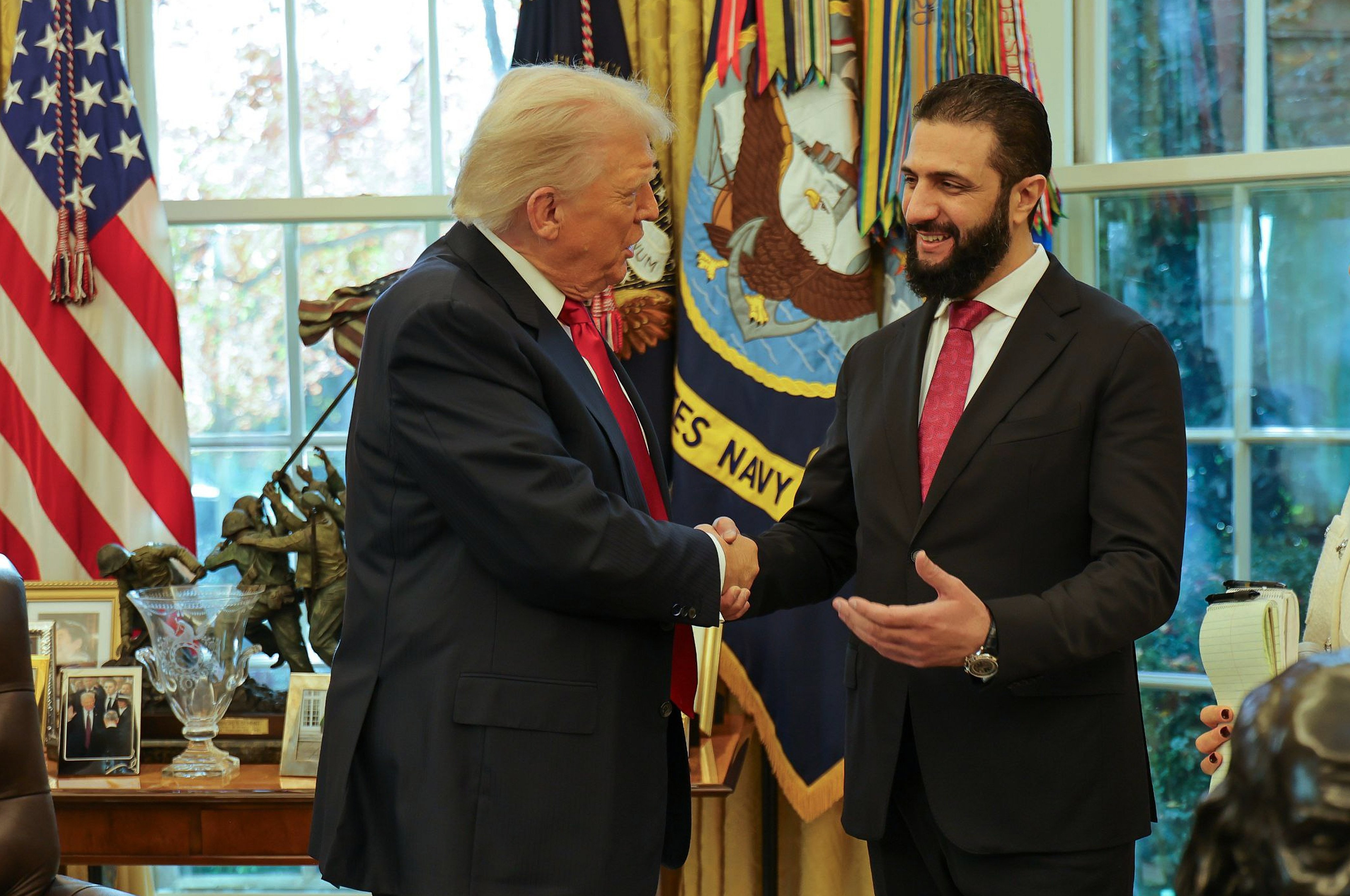 US President Donald Trump shakes hands with Syria’s President Ahmed al-Sharaa in the Oval Office. Photo: Syrian Presidency Press Office via AP