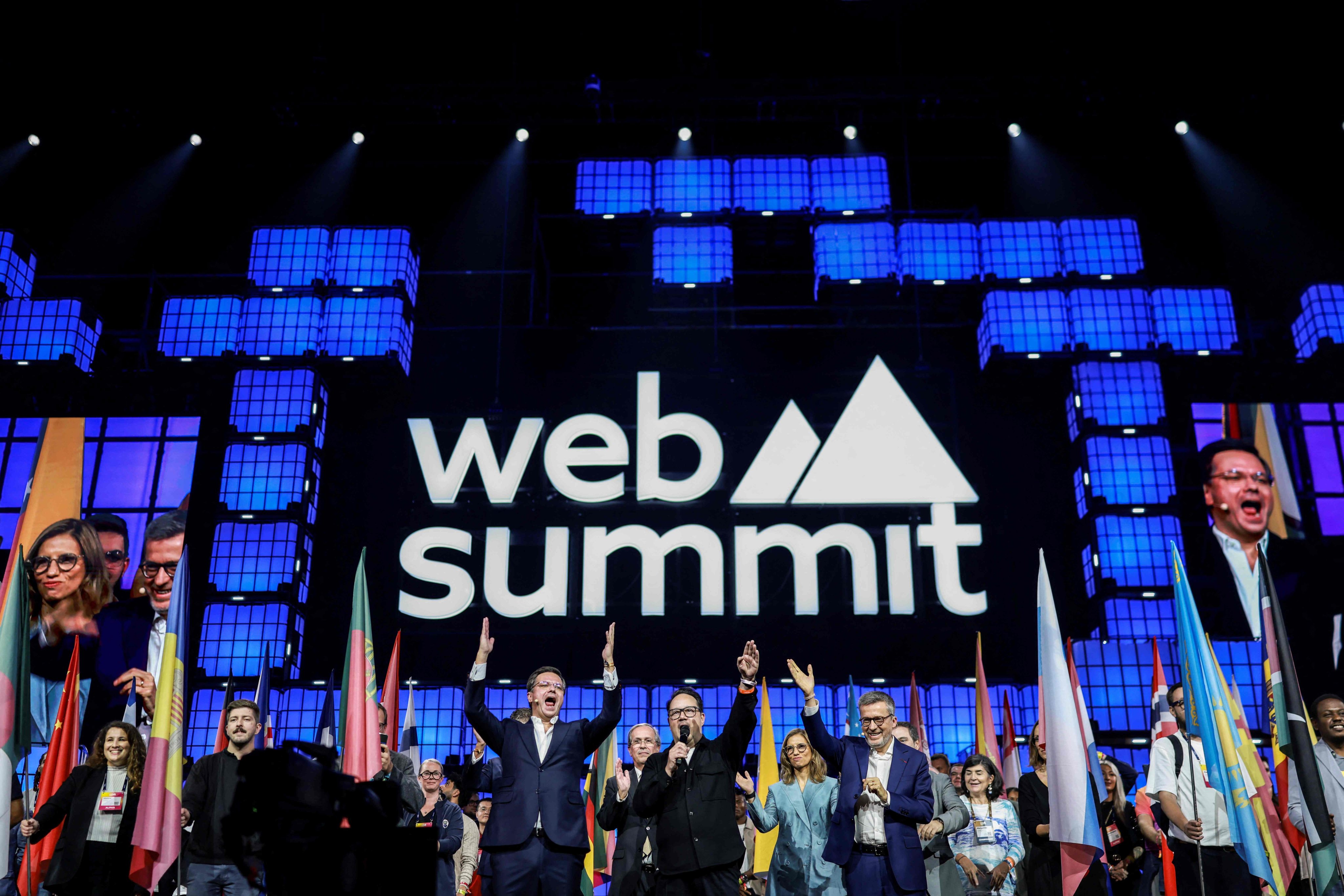 Portuguese Minister of State Reform Goncalo Matias (left) and Lisbons Mayor Carlos Moedas, right, (right, with microphone) cheer during the opening ceremony of Web Summit 2025 at Parque das Nacoes in Lisbon, on Monday. The summit will run until November 14. Photo: AFP