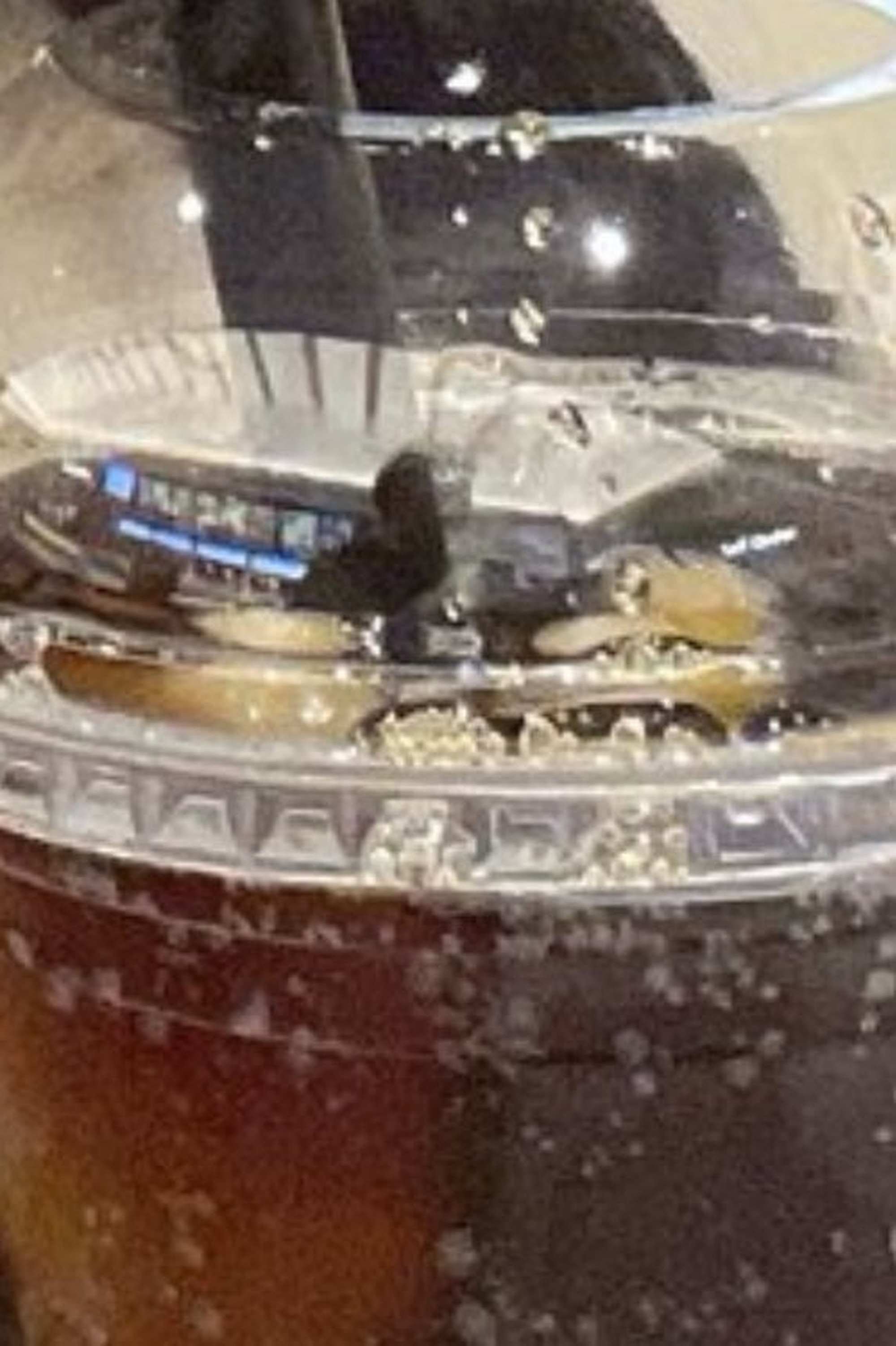 Eagle-eyed fans noticed a man’s reflection in a plastic cup cap, igniting speculation about her cinema date. Photo: X.com@nani_nani_