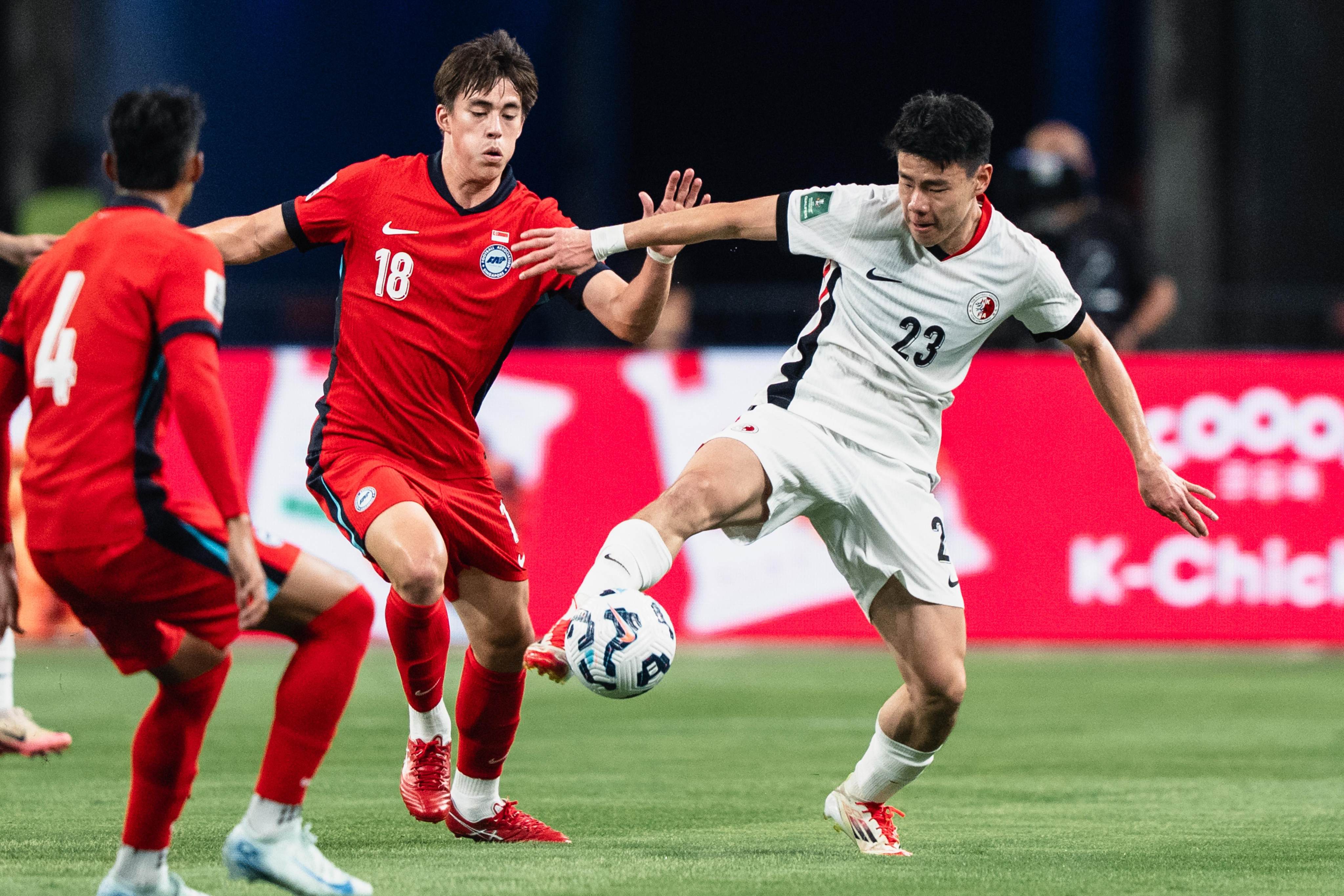 Hong Kong’s Sun Ming-him (right) fends off Singapore’s Harhys Stewart during the teams’ 0-0 Asian Cup qualifying stalemate in Singapore in March. Photo: WhatsApp