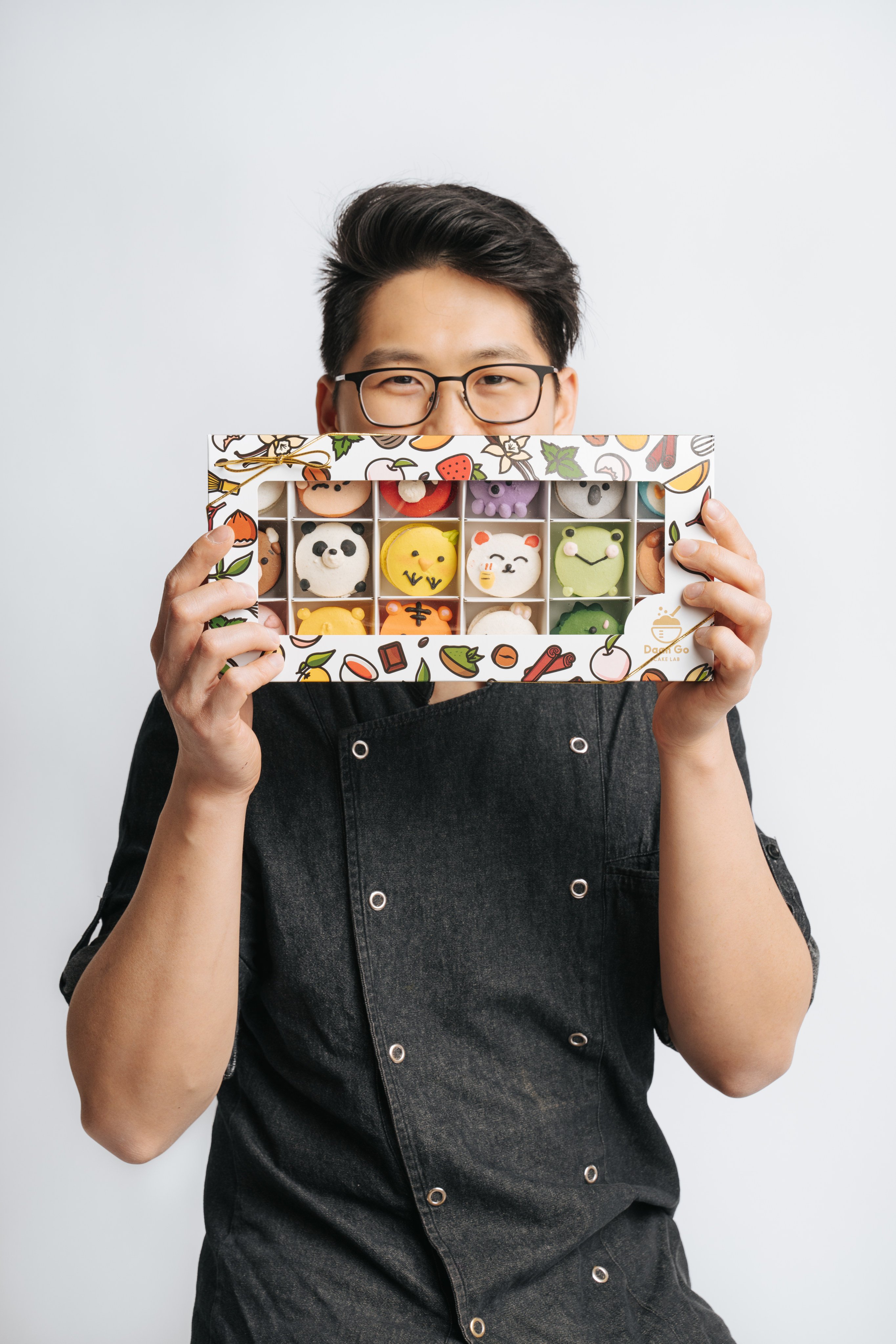 Chris Siu holds desserts from his bakery, Daan Go Cake Lab, which now has several branches across Canada. Siu was eliminated in the quarter-finals of MasterChef Canada season two in 2015, but tried again years later and won. Photo: White Book Studio