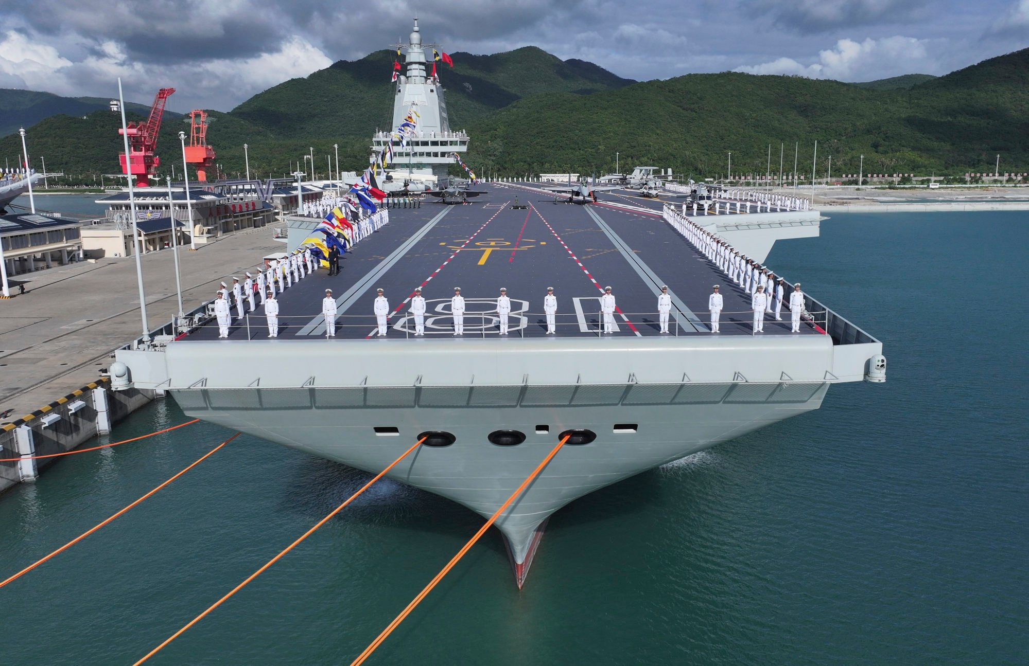 People’s Liberation Army Navy crew stand at attention on deck during the commissioning and flag-presenting ceremony of the Fujian, China’s first aircraft carrier equipped with electromagnetic catapults. Photo: Xinhua