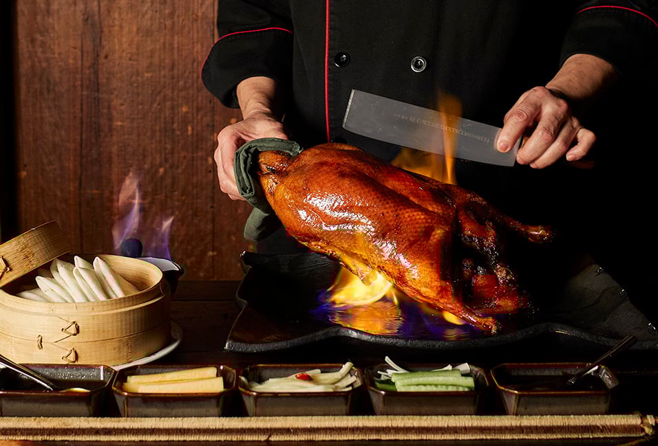The signature Peking duck at Hong Kong’s Hutong restaurant is flamed and carved at the table. Photo: Hutong