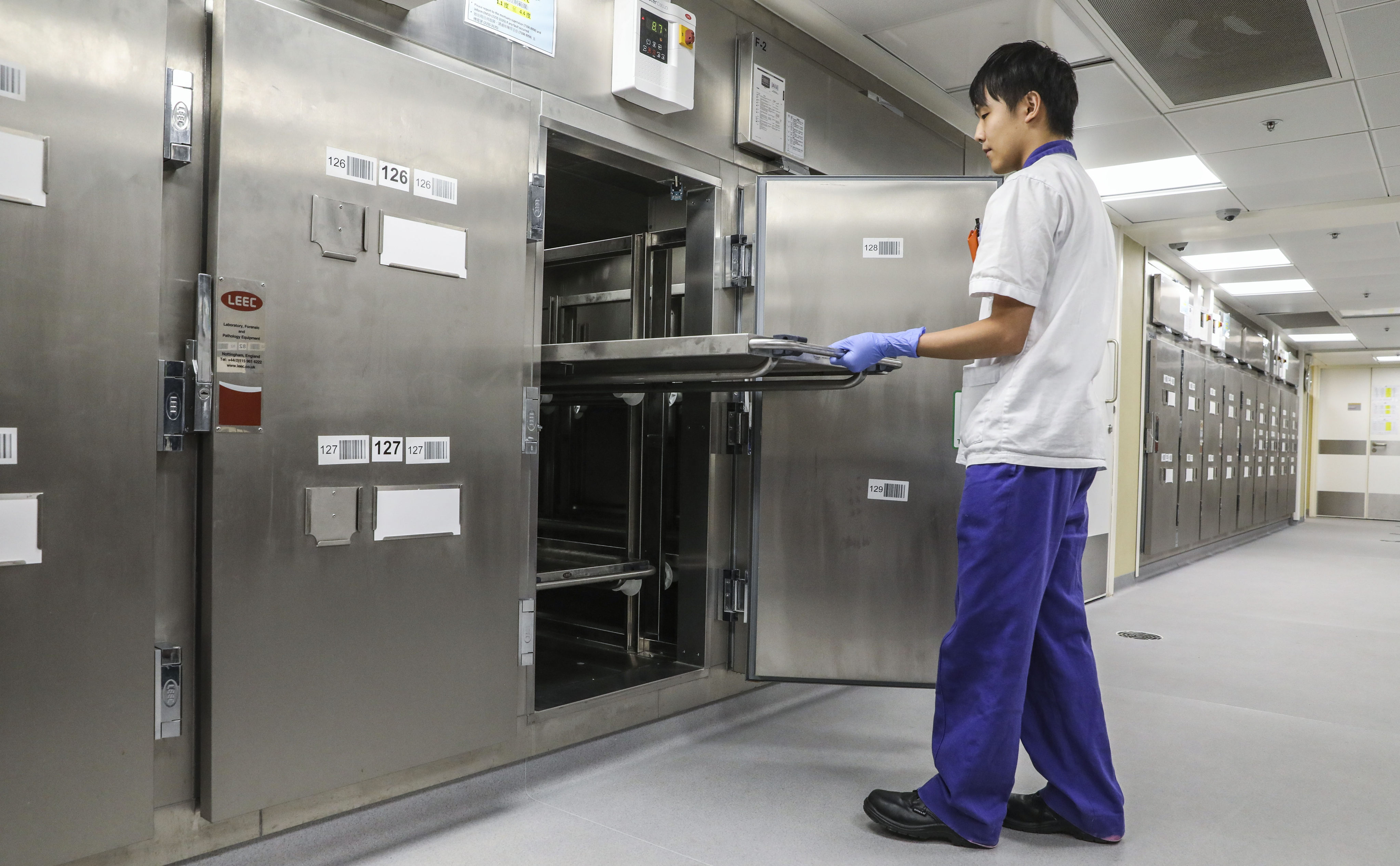 A patient care assistant works at the mortuary at Queen Mary Hospital in Pok Fu Lam, on September 18, 2018. Photo: K. Y. Cheng