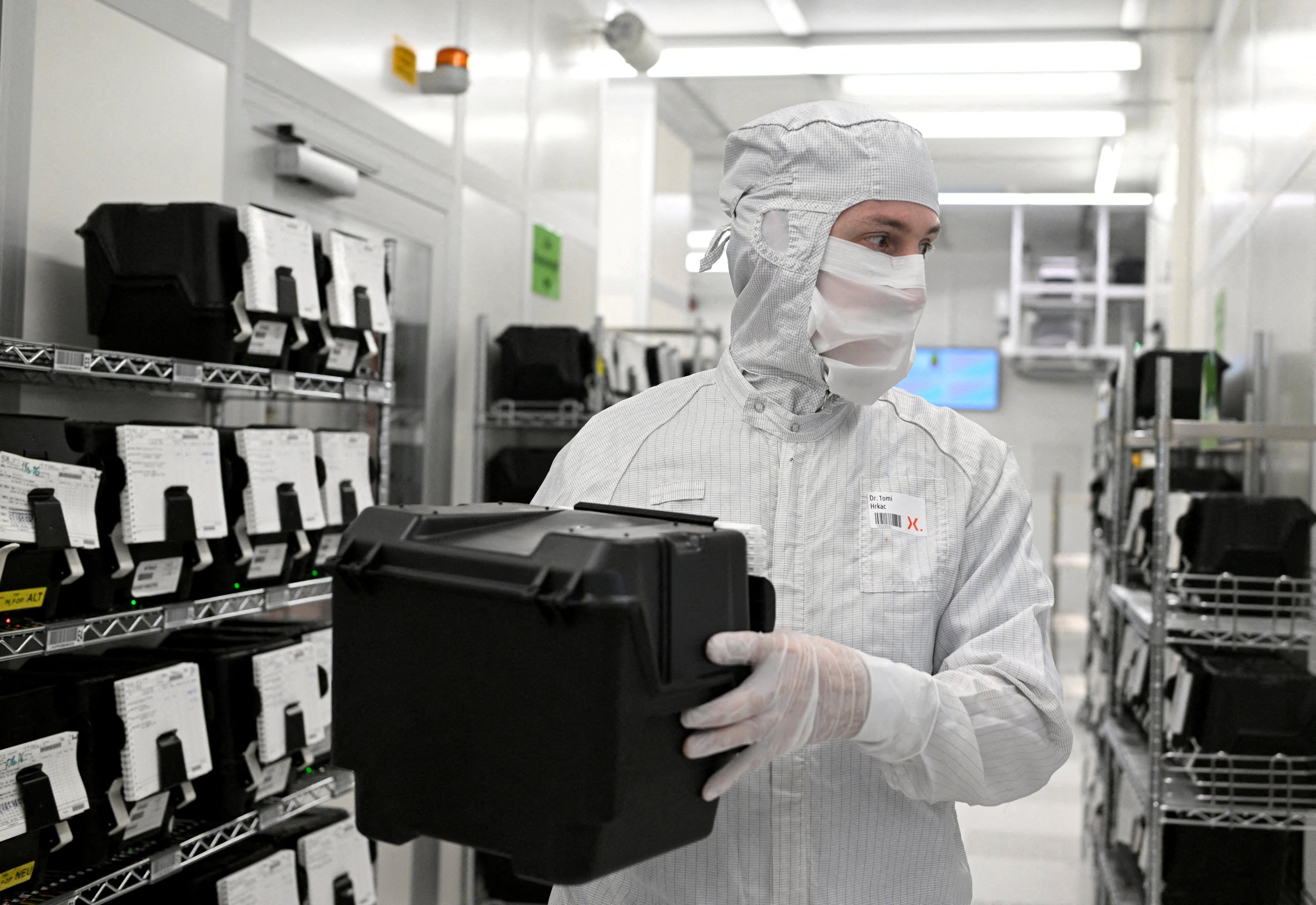 An employee holds a box with wafers in a production line of Dutch semiconductor company Nexperia in Hamburg, Germany, on June 27, 2024. Photo: Reuters