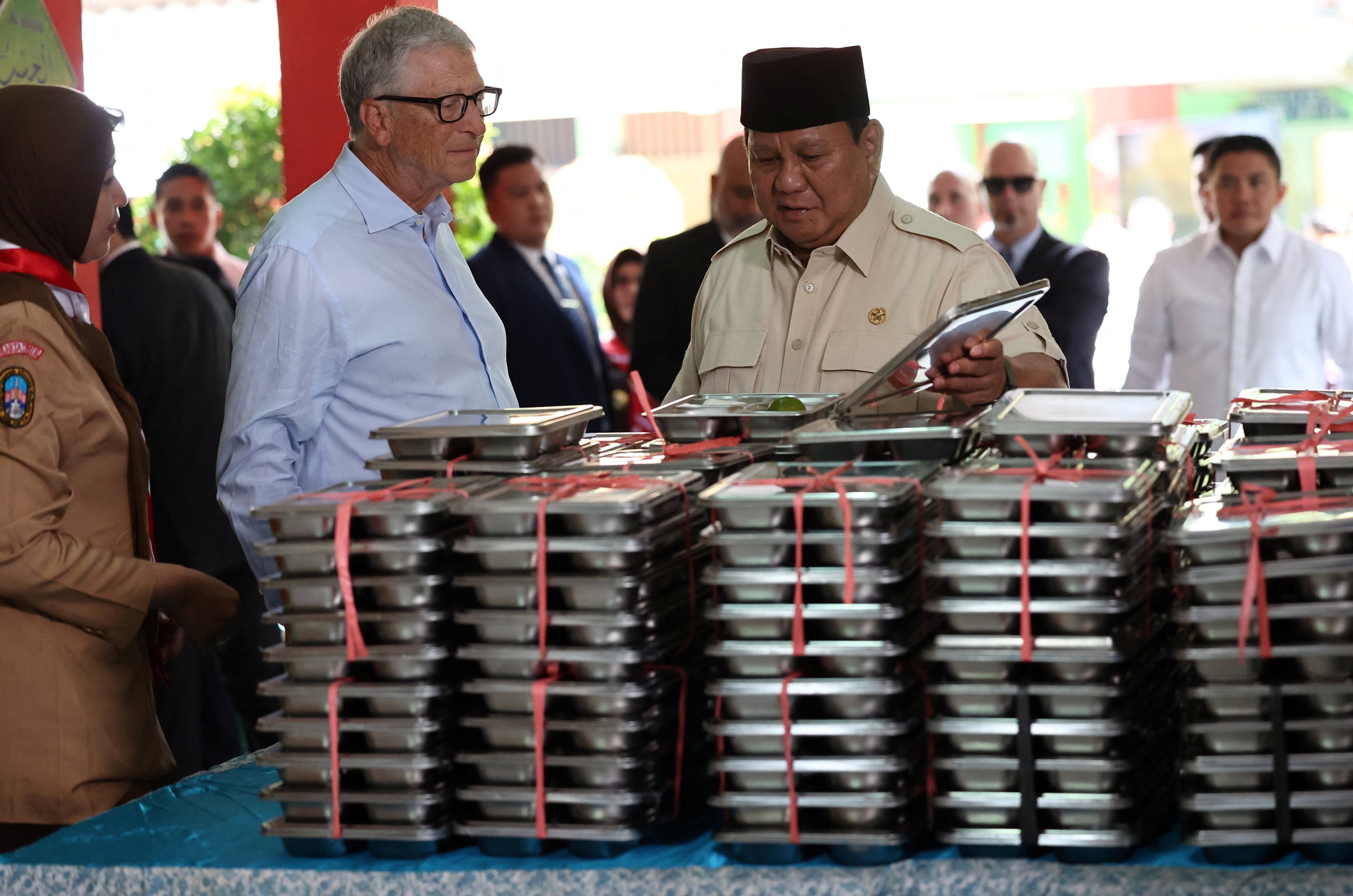 Bill Gates (left) and Indonesian President Prabowo Subianto inspect meal boxes during a visit to a Jakarta school to inspect the free nutritious meals programme in May. Photo: Reuters