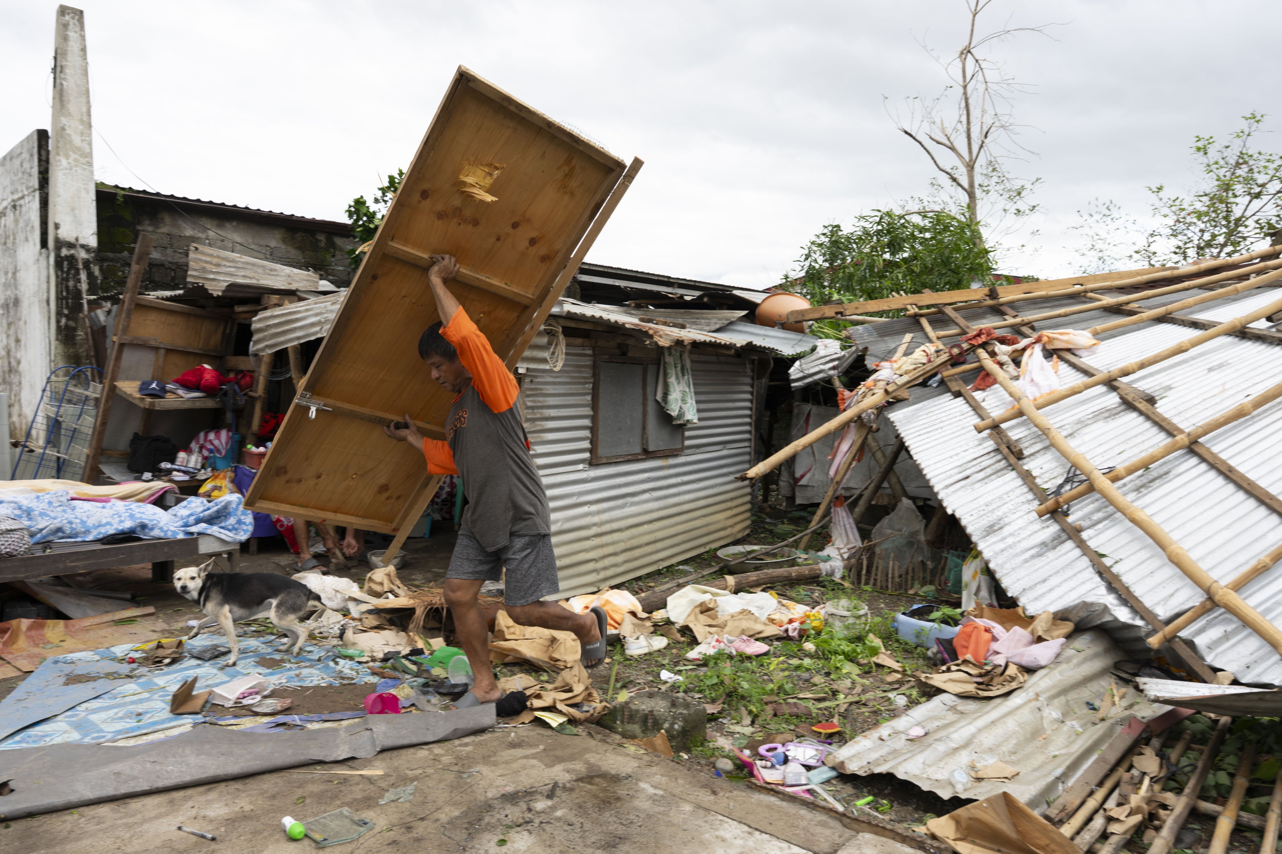 People return to a house damaged by Typhoon Fung-wong in Isabela province, northern Philippines, on Monday. Photo: EPA