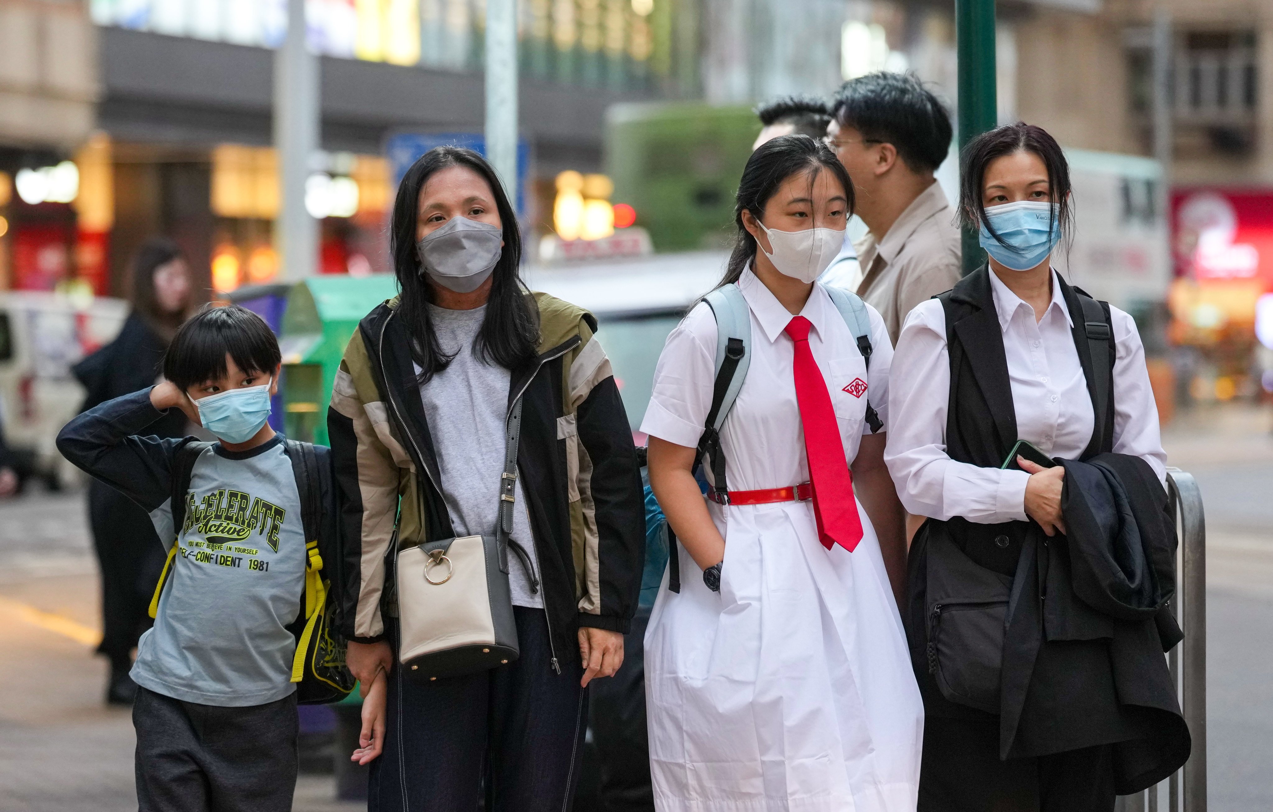 People wear masks in Kennedy Town as a precaution against the flu. Photo: Karma Lo