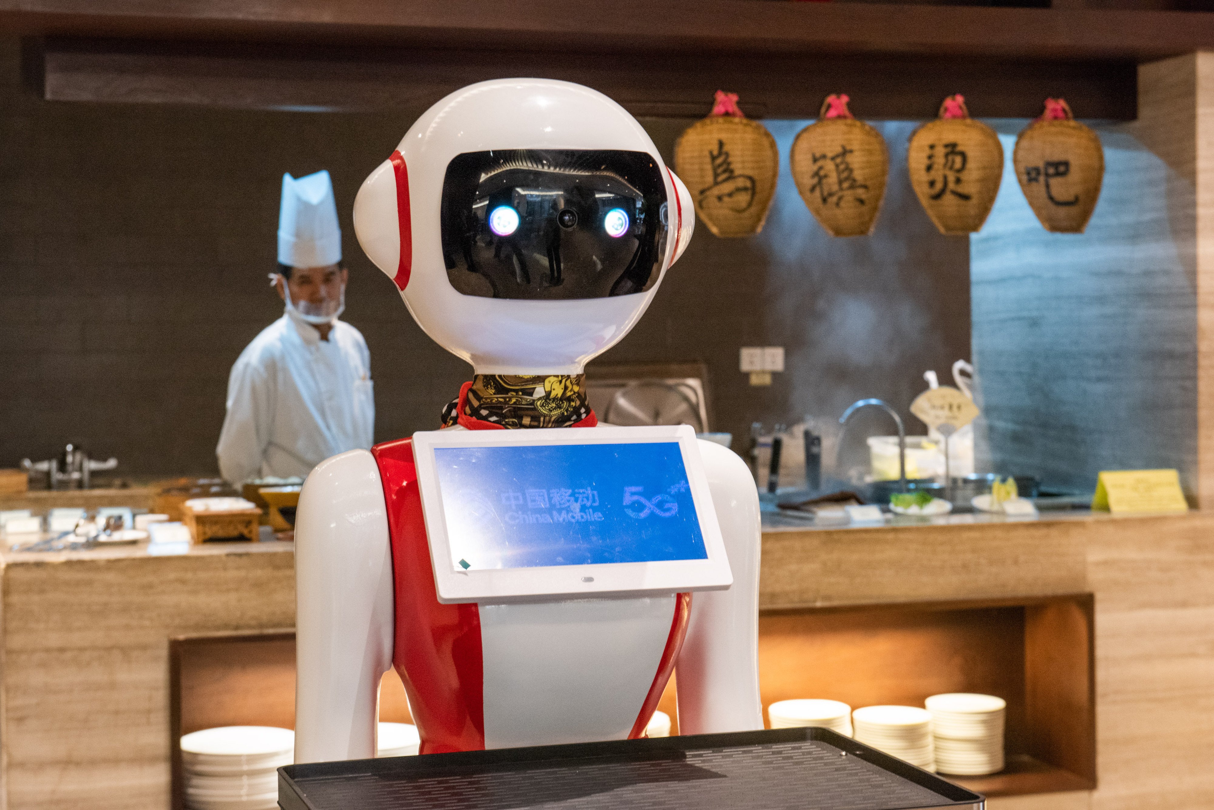 A server robot waits tables at a restaurant in China’s eastern Zhejiang province. Automation is rapidly spreading in China’s vast catering sector, with Shanghai aiming to accelerate the rollout of new technologies. Photo: Xinhua
