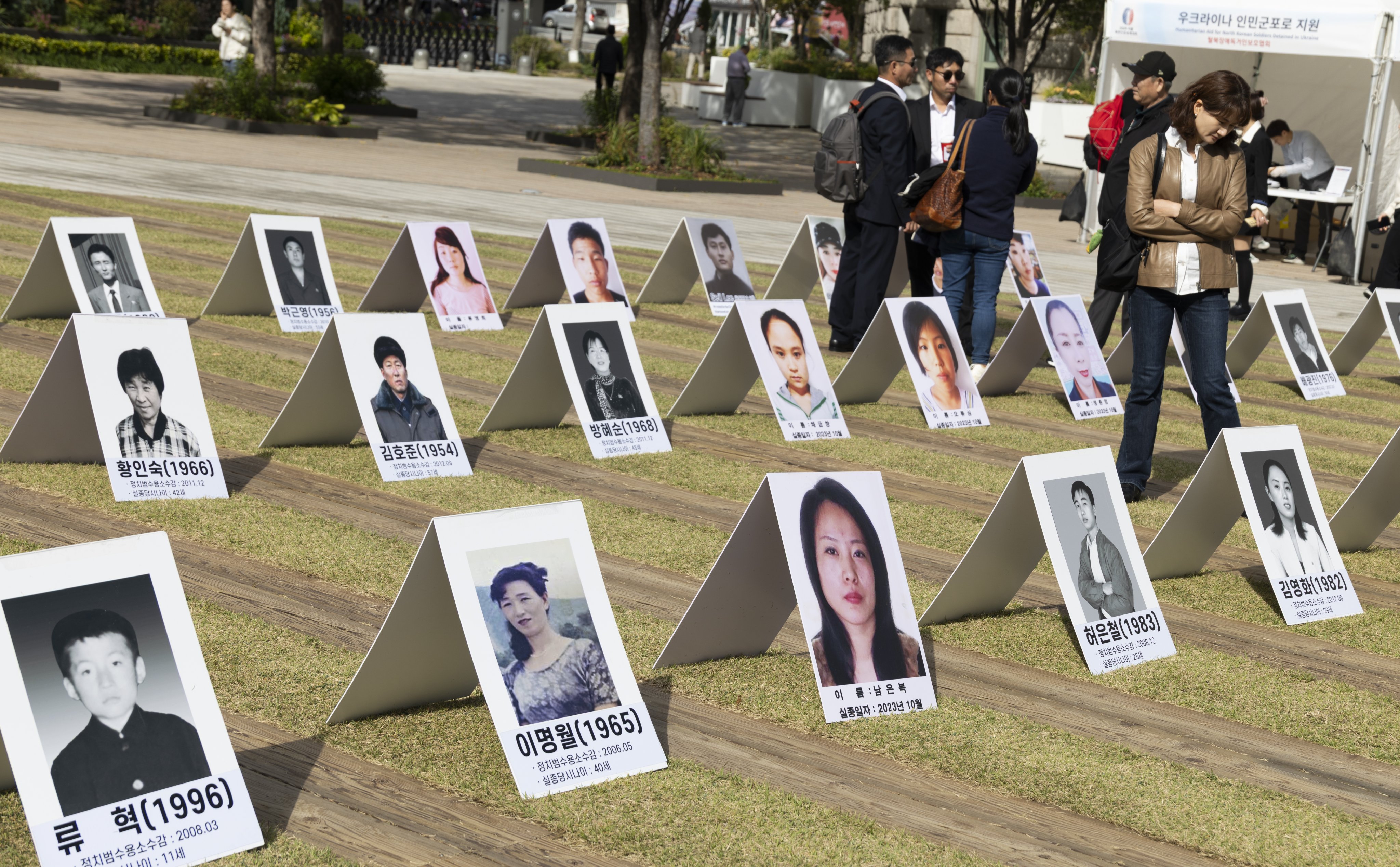People look at pictures of North Koreans missing in North Korea during an exhibition in Seoul, South Korea, in October. Photo: EPA