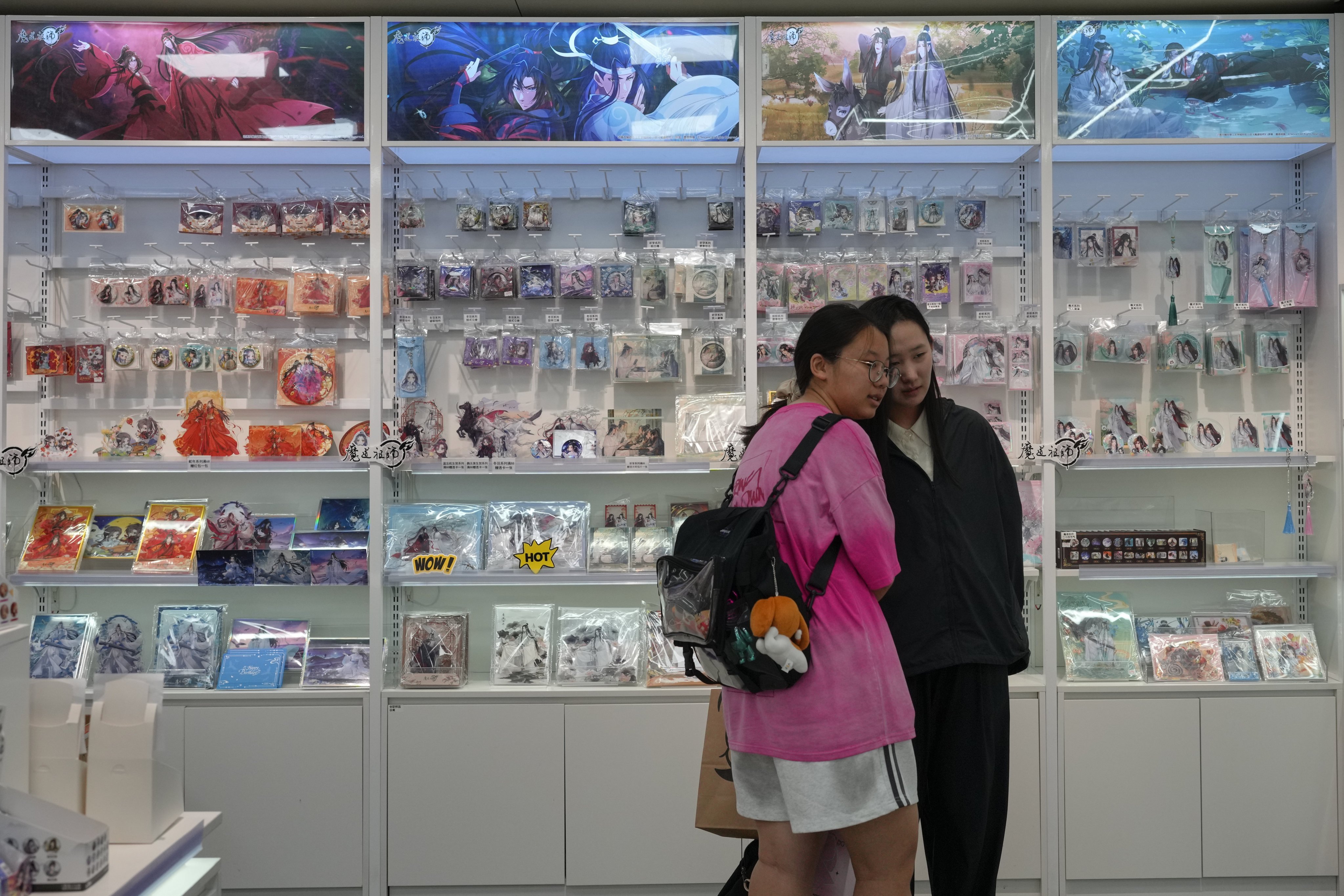 Women near shelves of merchandise for danmei stories in a comic store in Beijing. China is cracking down on stories about men in love. Photo: AP