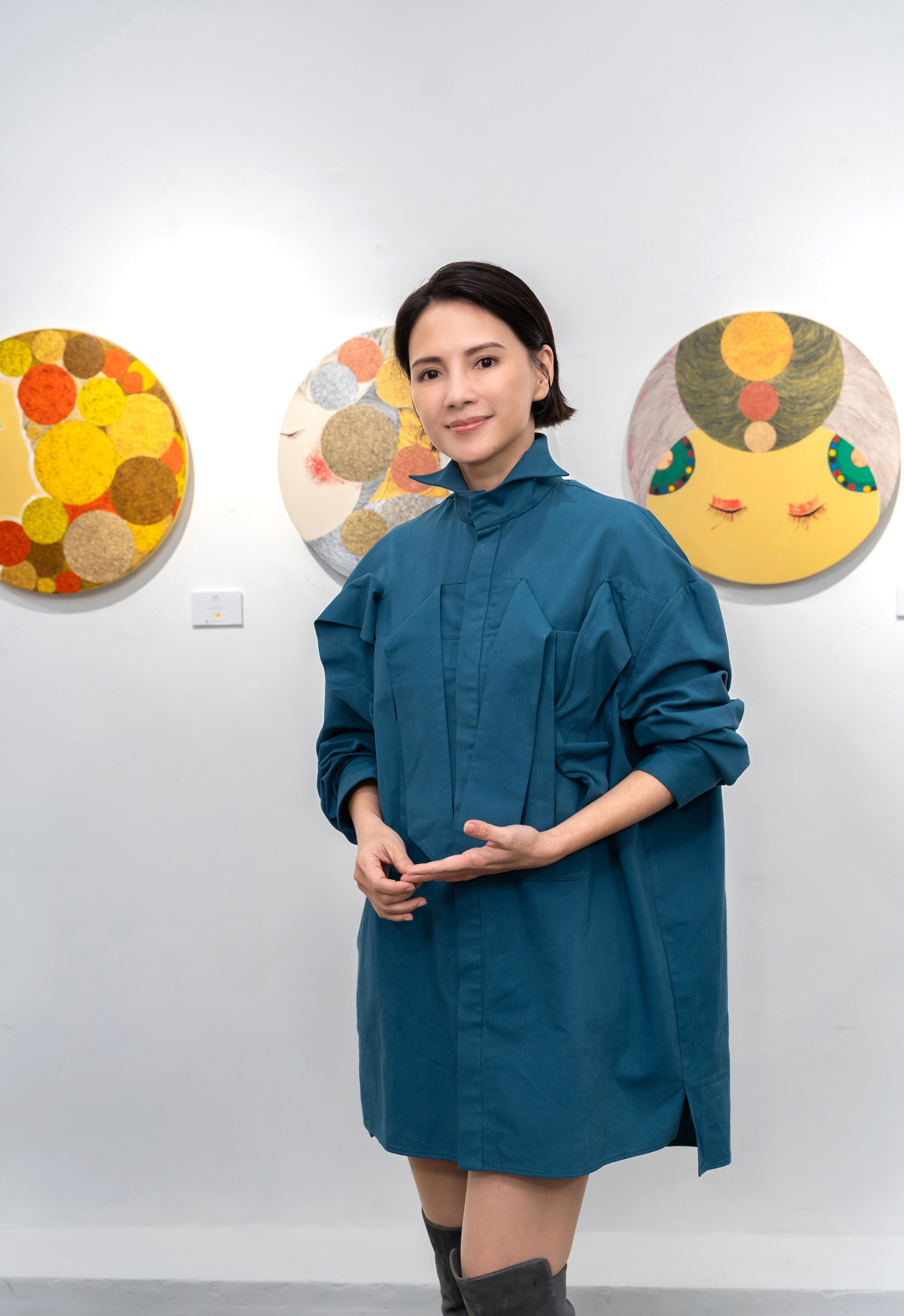 Angelica Lee Sinje stands before some of her paintings featured in Childtopia, her first Hong Kong solo exhibition, at 13a New Street Art Gallery in Sheung Wan. Photo: 13A New Street Art Gallery