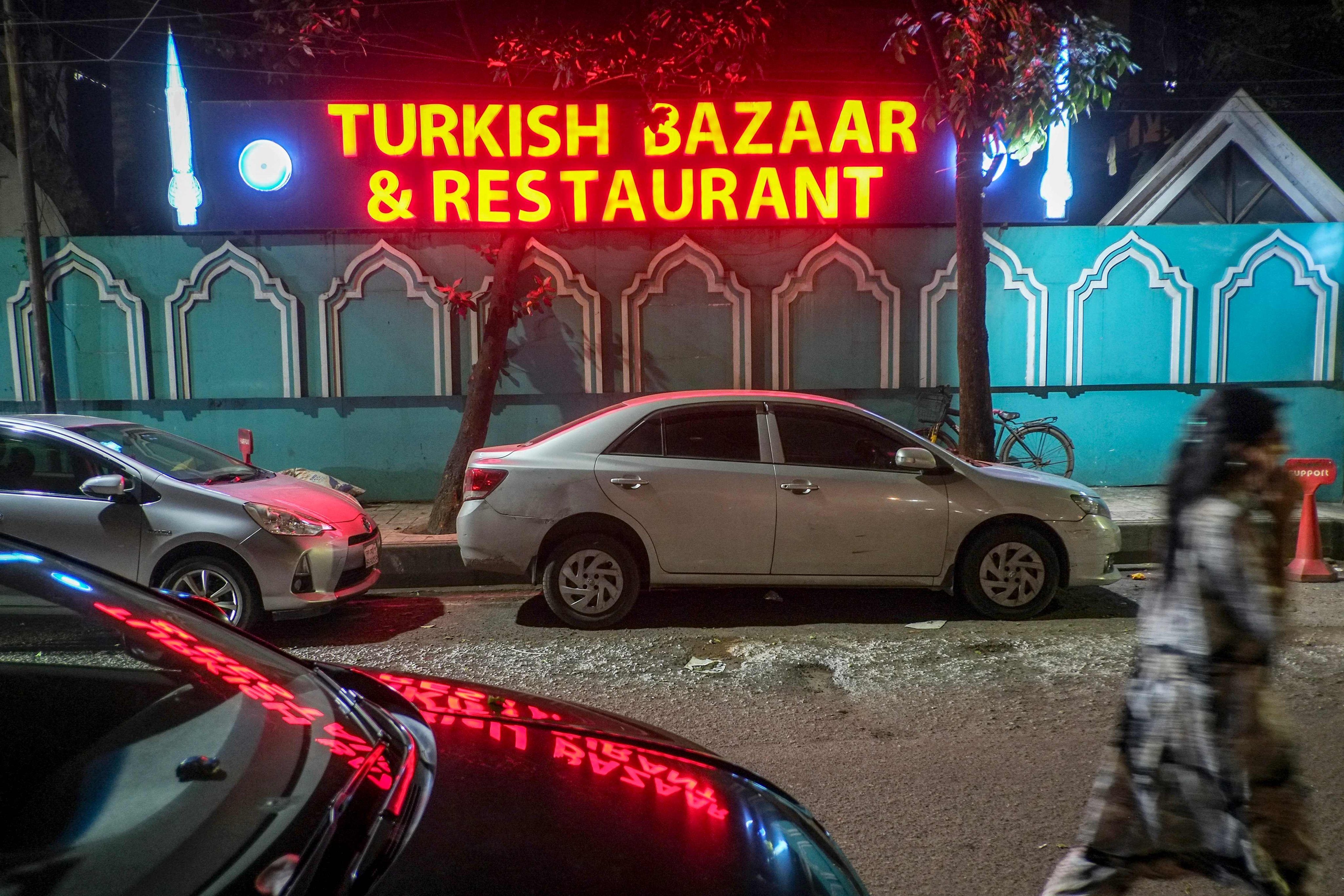 A woman walks past a Turkish restaurant in Dhaka on October 31. More Turkish restaurants are opening in Bangladesh and there is a general interest in learning the language. Photo: AFP