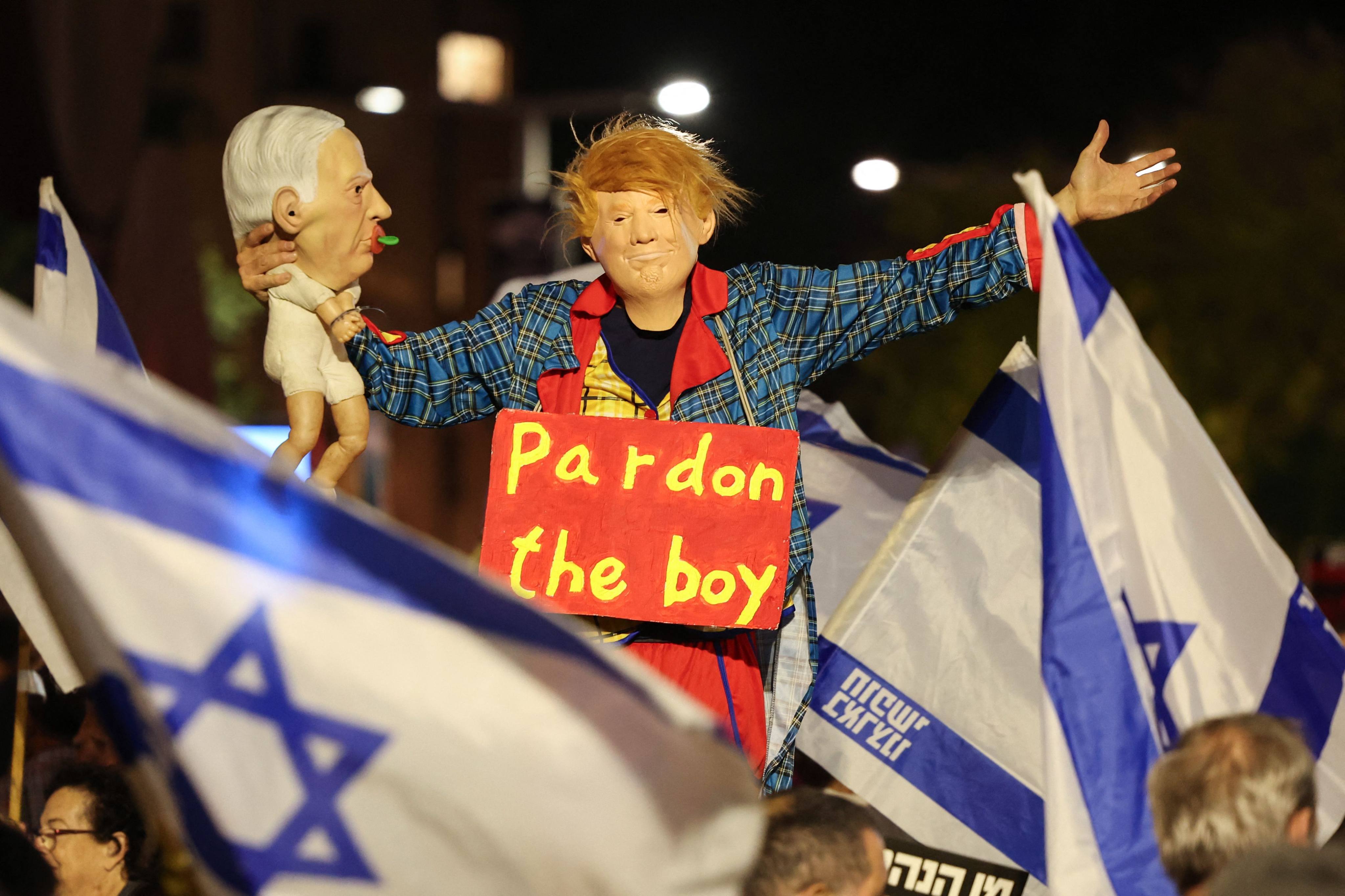 An Israeli anti-government protester dressed up as US President Donald Trump holds a doll depicting Prime Minister Benjamin Netanyahu during a demonstration against Netanyahu and in support of establishing a state commission of inquiry into Hamas’ October 7, 2023 attacks on Israel, in Habima Square in Tel Aviv on Saturday. Photo: AFP