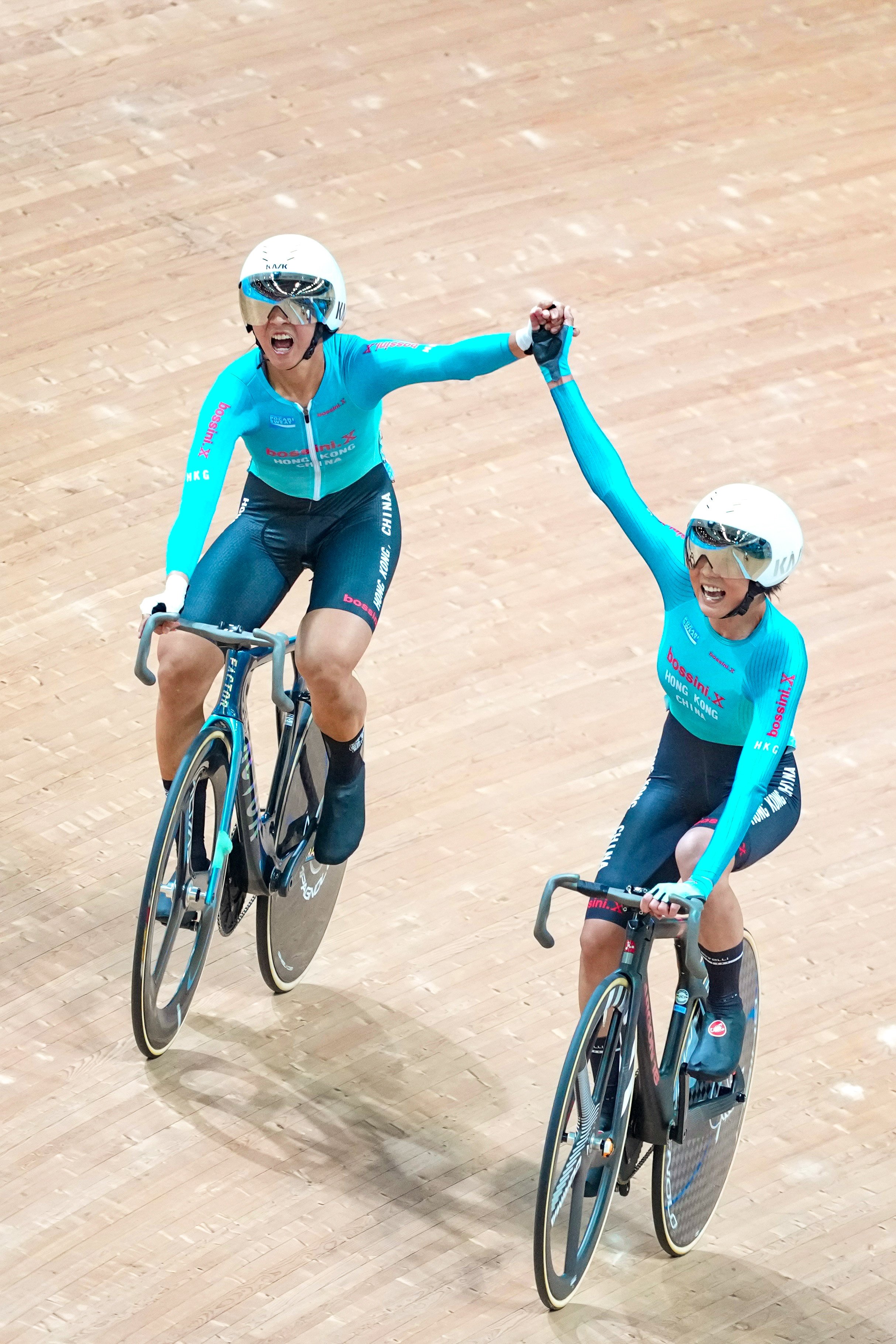 Hong Kong cyclists Ceci Lee (left) and Chloe Leung celebrate after winning the Madison race at the National Games on Sunday. Photo: Karma Lo