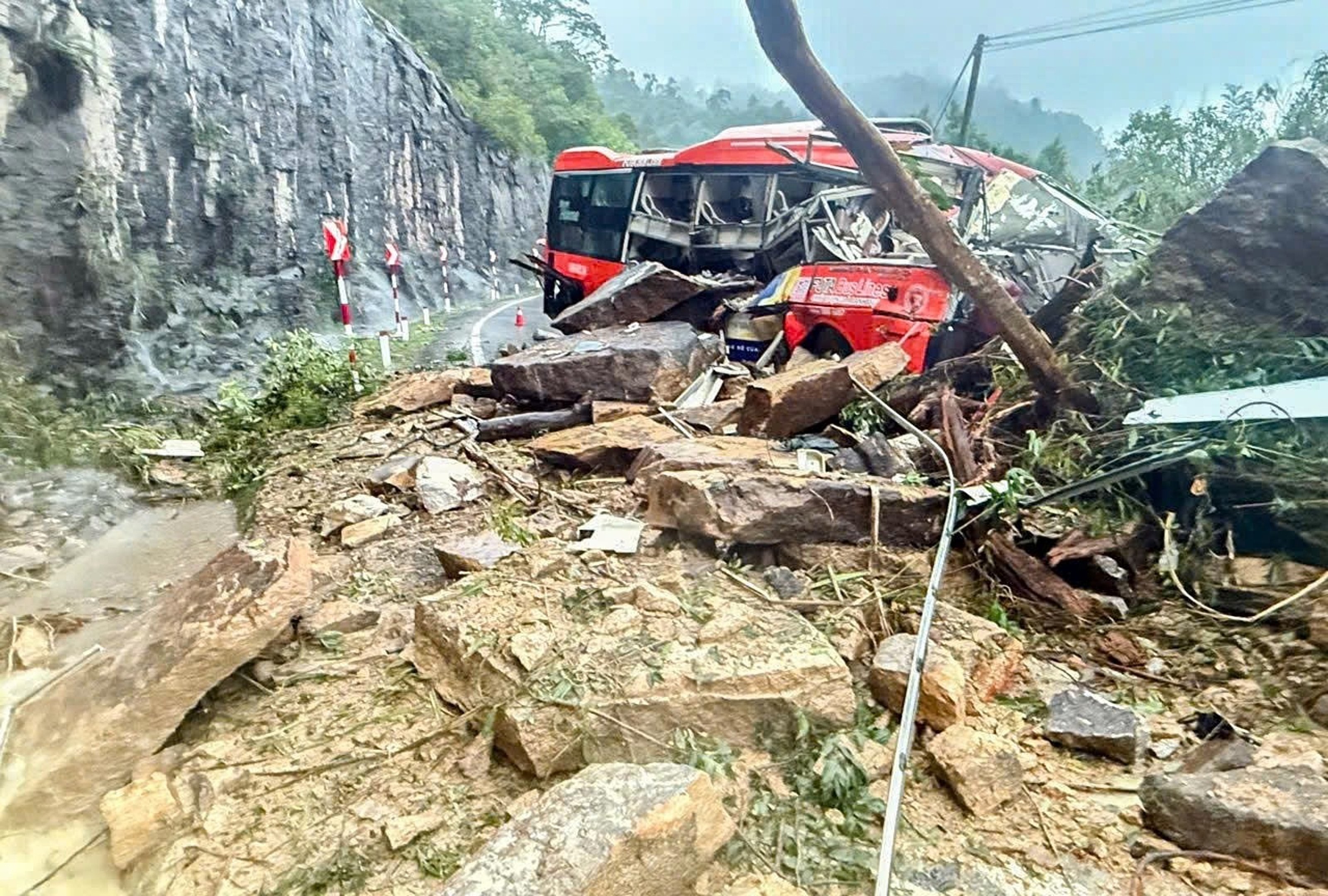 A passenger bus is crushed by a landslide on Khanh Le pass in Khanh Hoa province, Vietnam late on Sunday. Photo: VNExpress/AP