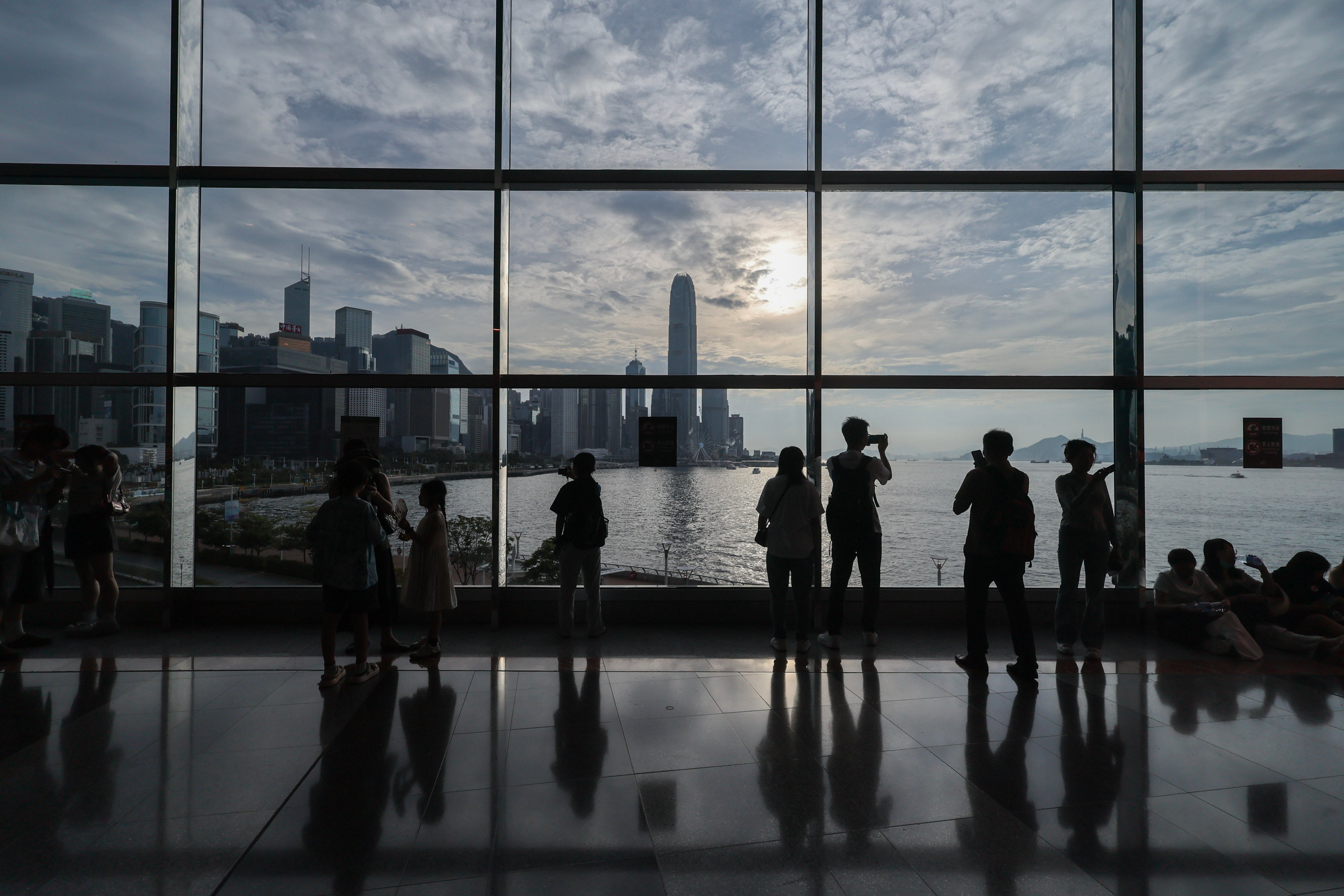 People enjoy the view from the Hong Kong Convention and Exhibition Centre in Wan Chai on July 19. Photo: Dickson Lee