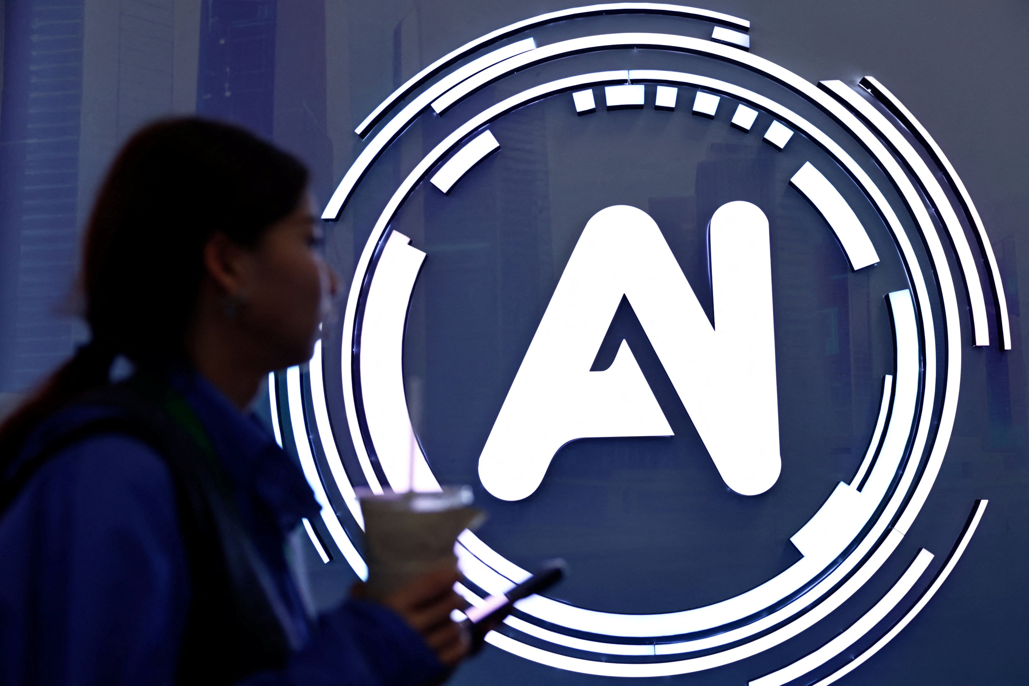 A woman walks past a sign at the World Internet Conference in Wuzhen town of Tongxiang city, Zhejiang province, on November 8, 2025. Photo: Reuters