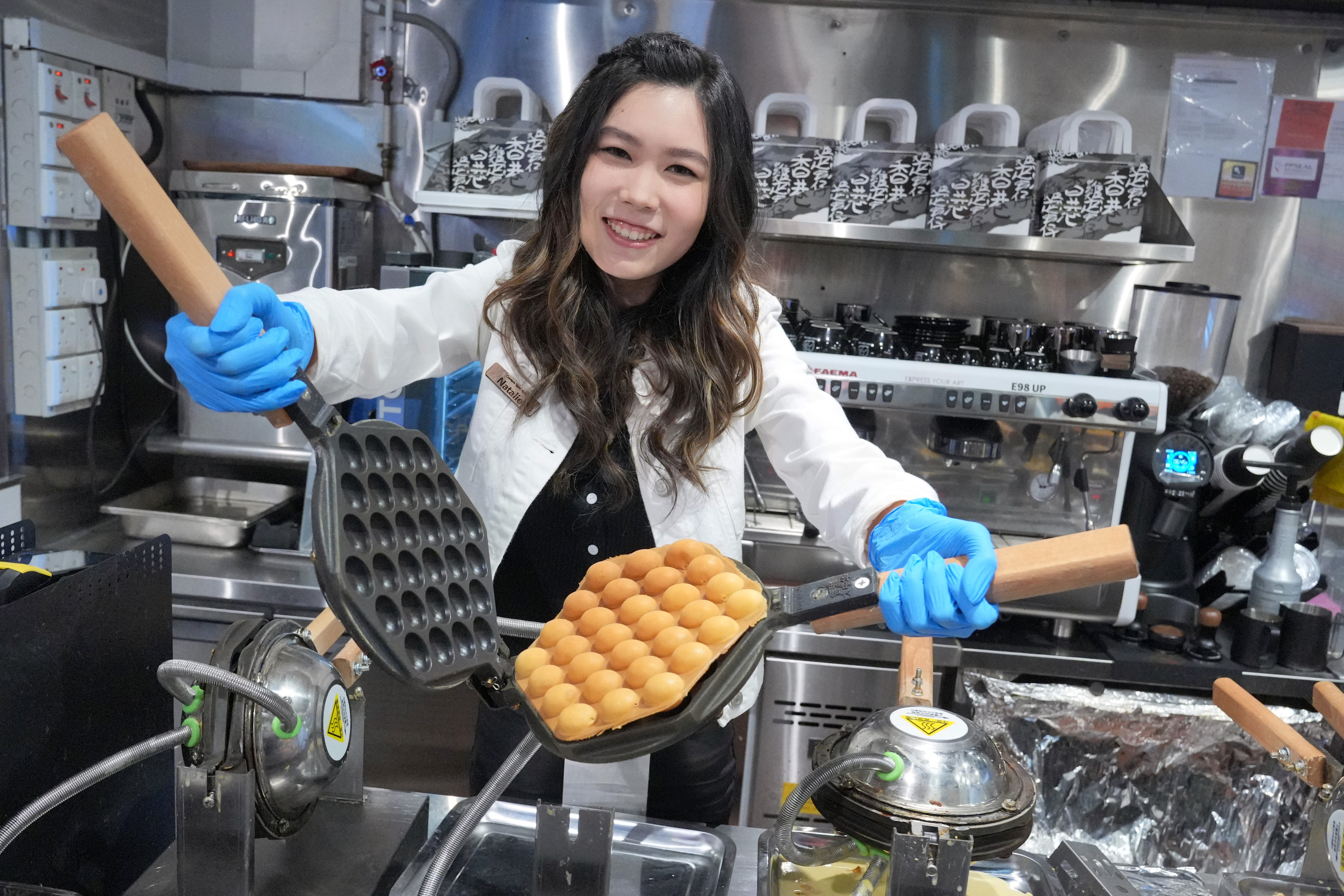 Pineapple bun egg waffles creator Natalie Lau Sze-wai poses at Chicken Egg Boy in Sheung Wan. Photo: May Tse
