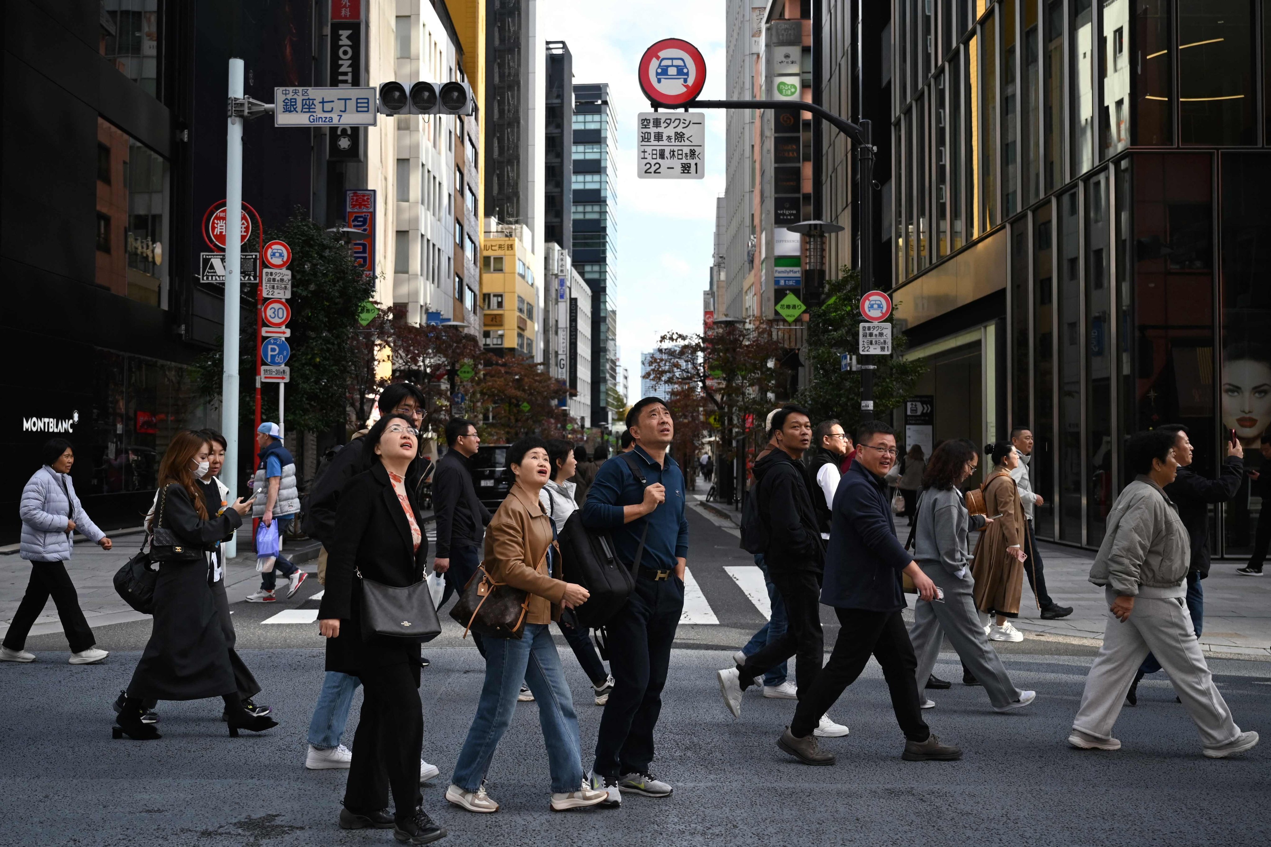 A Chinese tour group walks through the Ginza shopping district in Tokyo. China has advised its citizens to avoid travelling to Japan amid a diplomatic row between the two countries. Photo: AFP