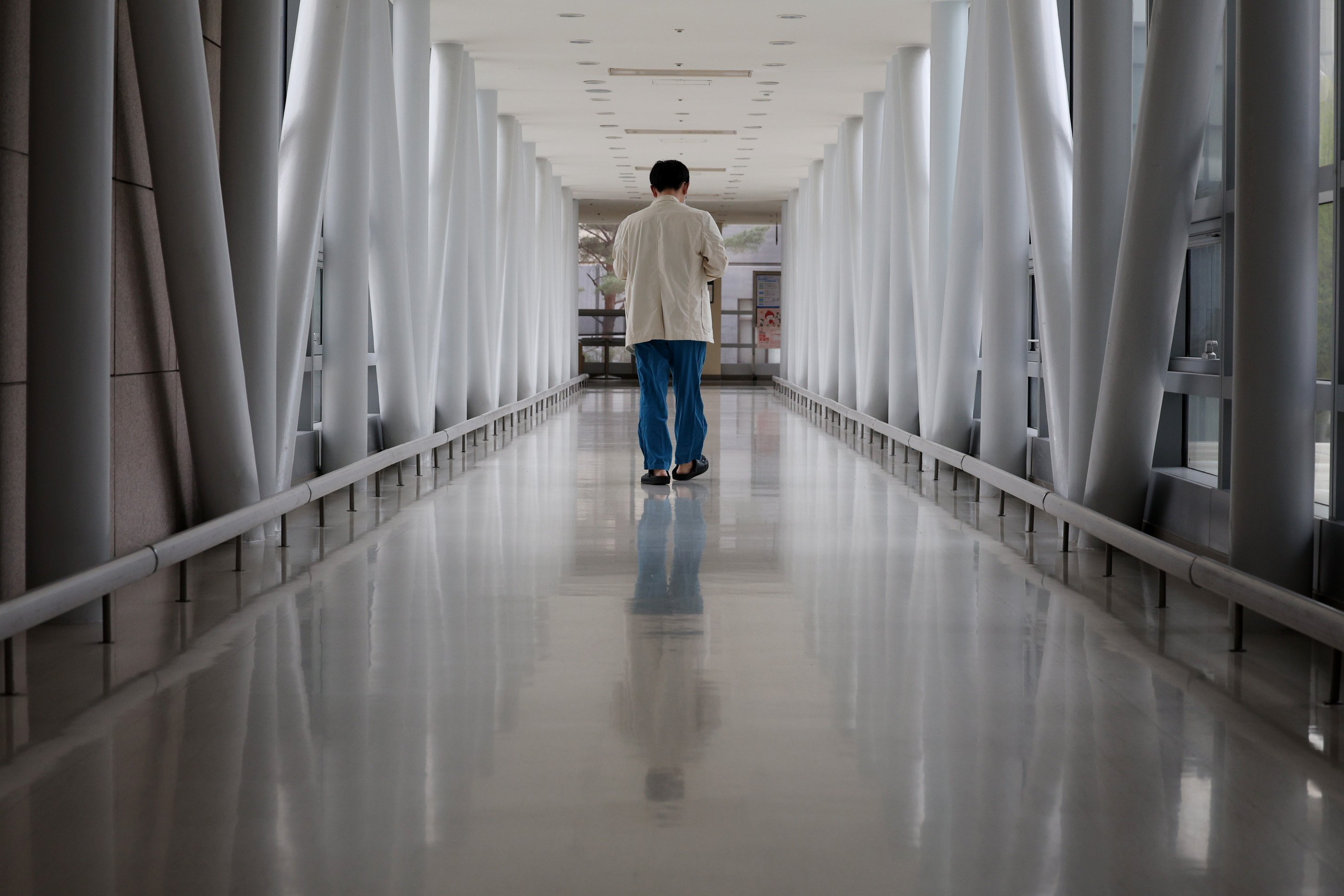 A medical worker walks down a hallway in a hospital in Seoul. South Korea has among the lowest ratios of doctors in the developed world. Photo: EPA-EFE/Yonhap
