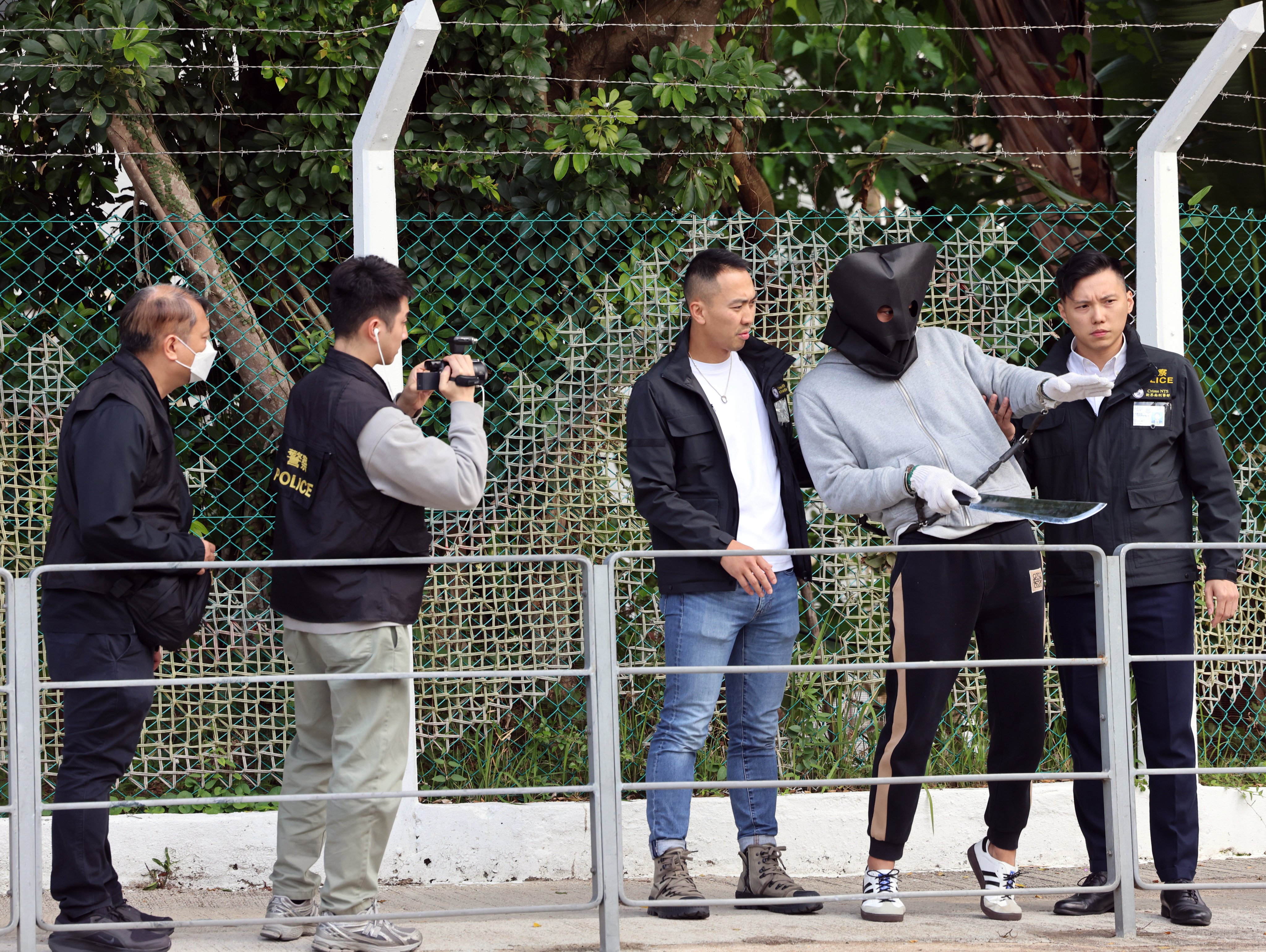 One of the suspects is brought to Fo Tan for a reconstruction of the crime in a previous arrangement. Photo: Jelly Tse