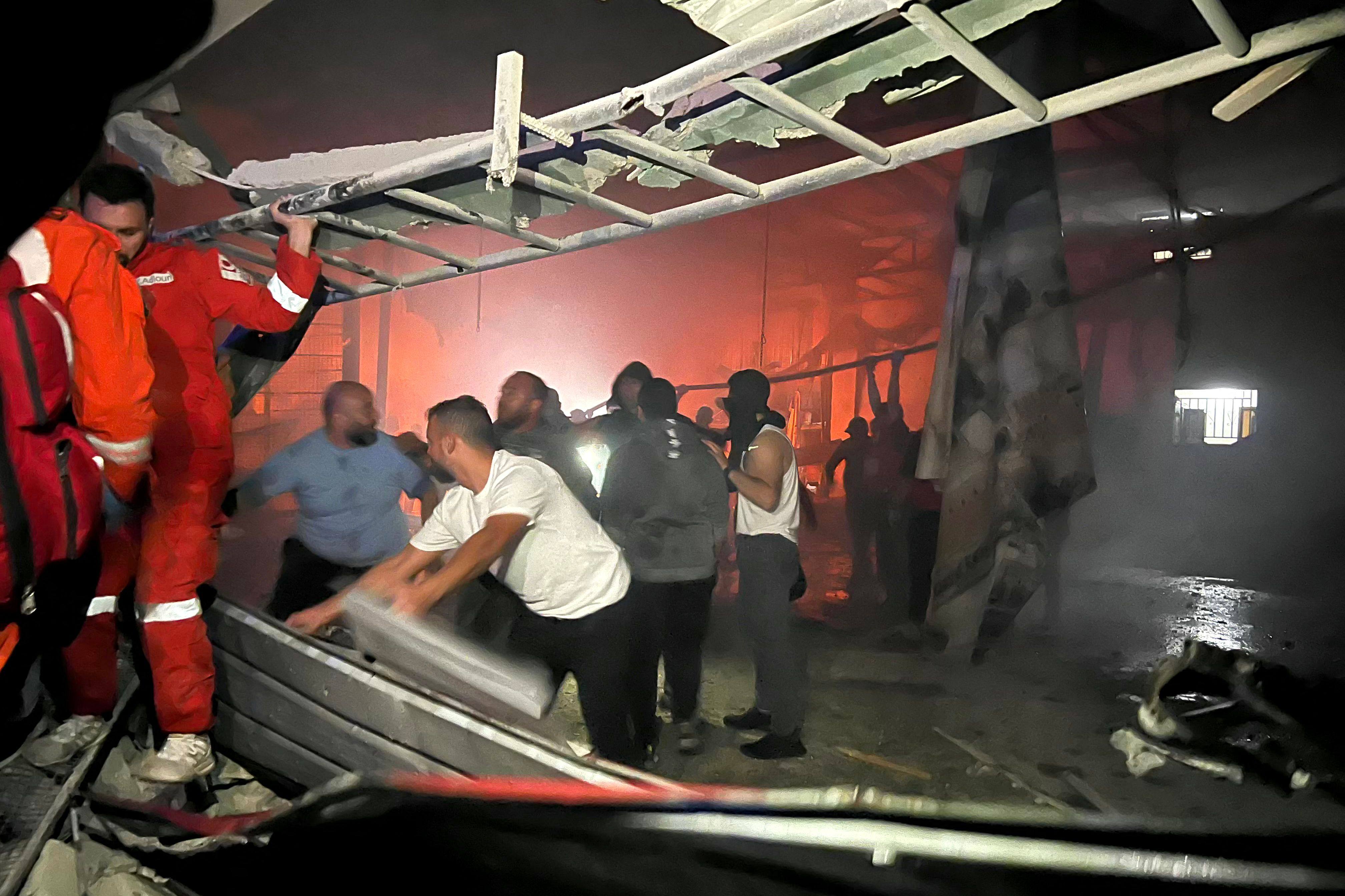 Rescuers search for survivors under rubble. Photo: AFP