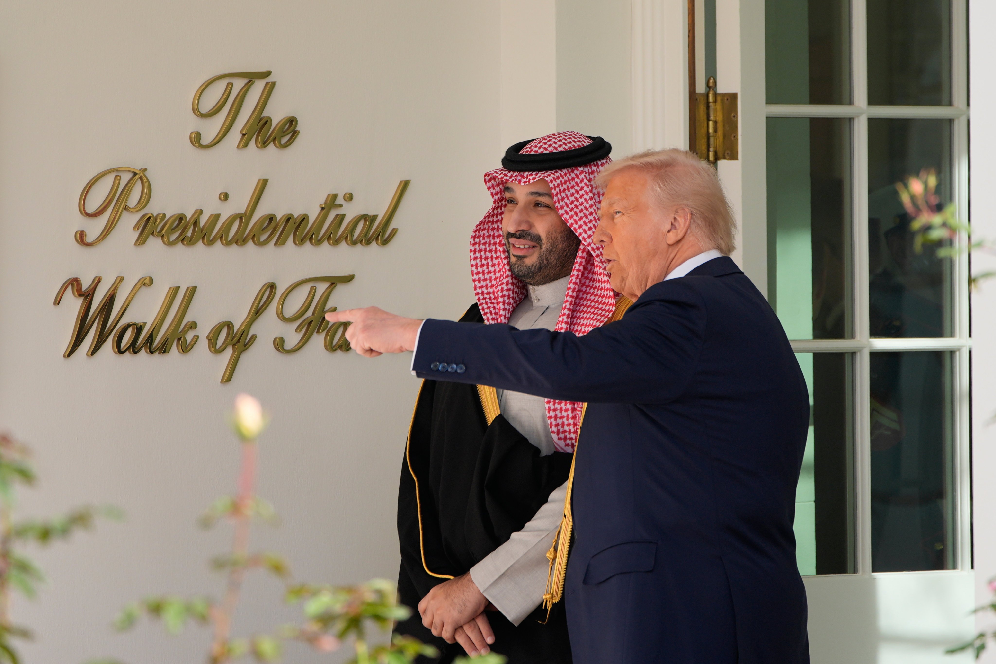 US President Donald Trump walks with Saudi Arabia’s Crown Prince Mohammed bin Salman along the colonnade at the White House. Photo: AP
