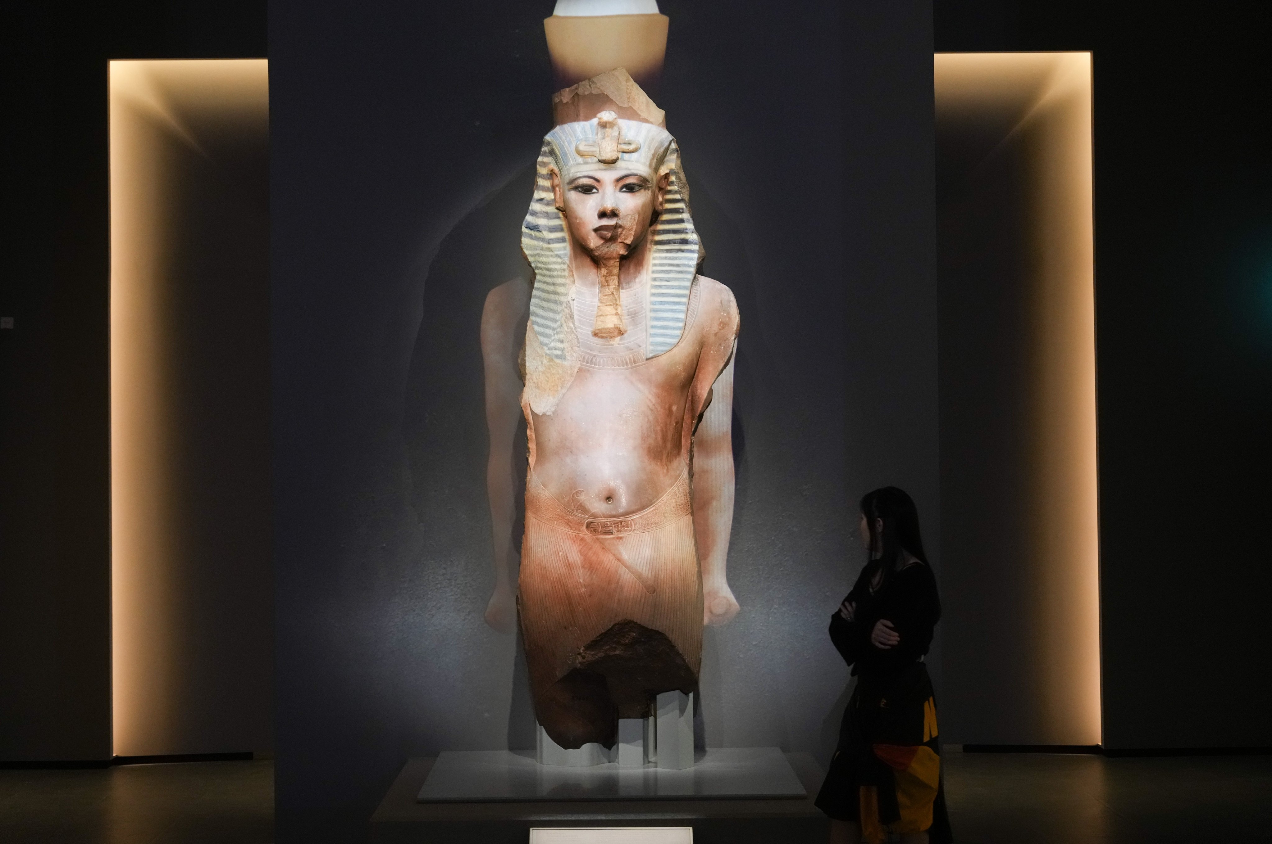 A statue of Tutankhamun is seen at the “Ancient Egypt Unveiled: Treasures from Egyptian Museums” exhibition at the Hong Kong Palace Museum. The statue has been made “whole” with special projection-mapping technology. Photo: Sam Tsang