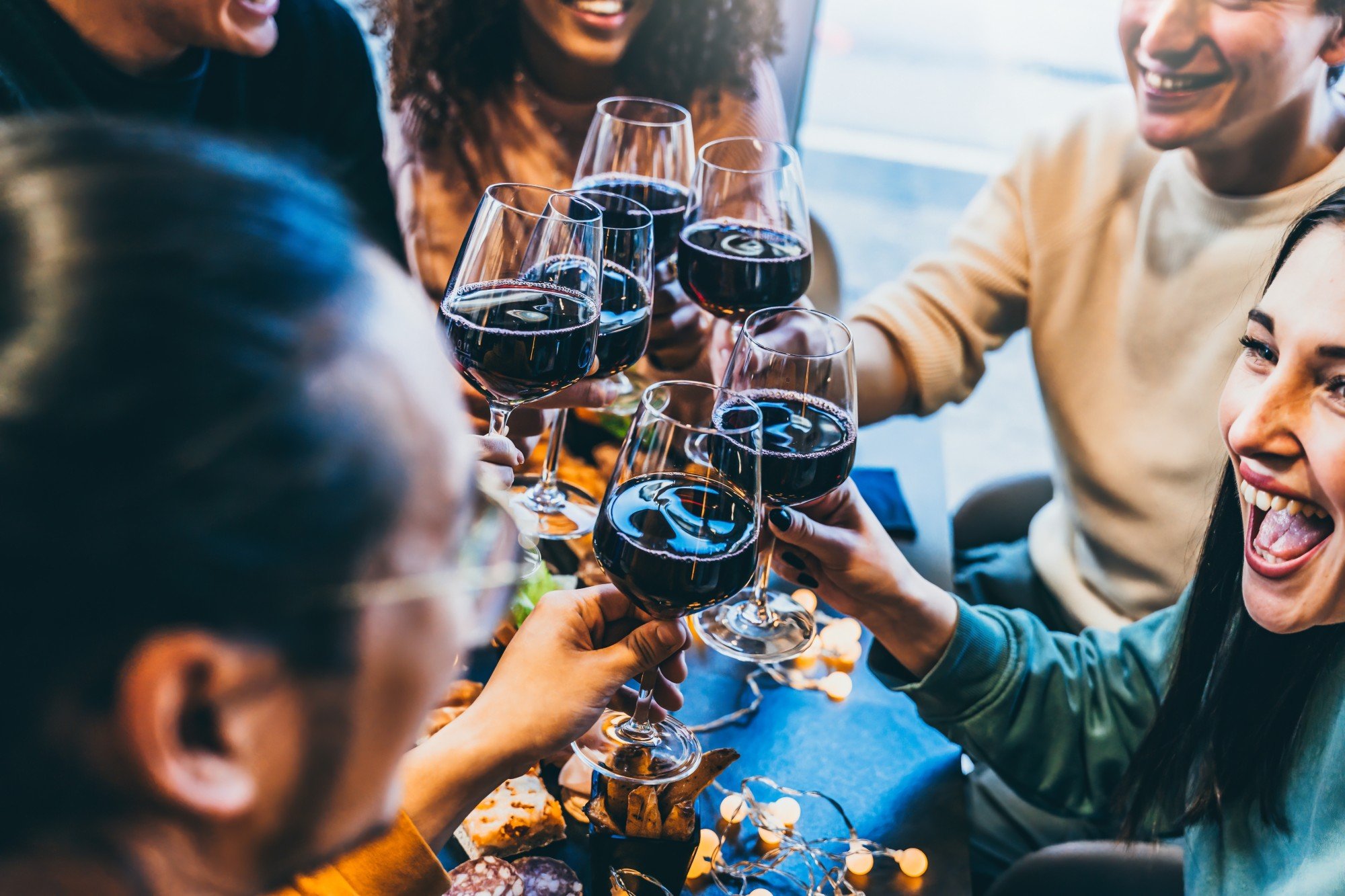 Happy friends toast each other as they enjoy a meal together. Experts say South Korea has to tackle bias against single people. Photo: Shutterstock