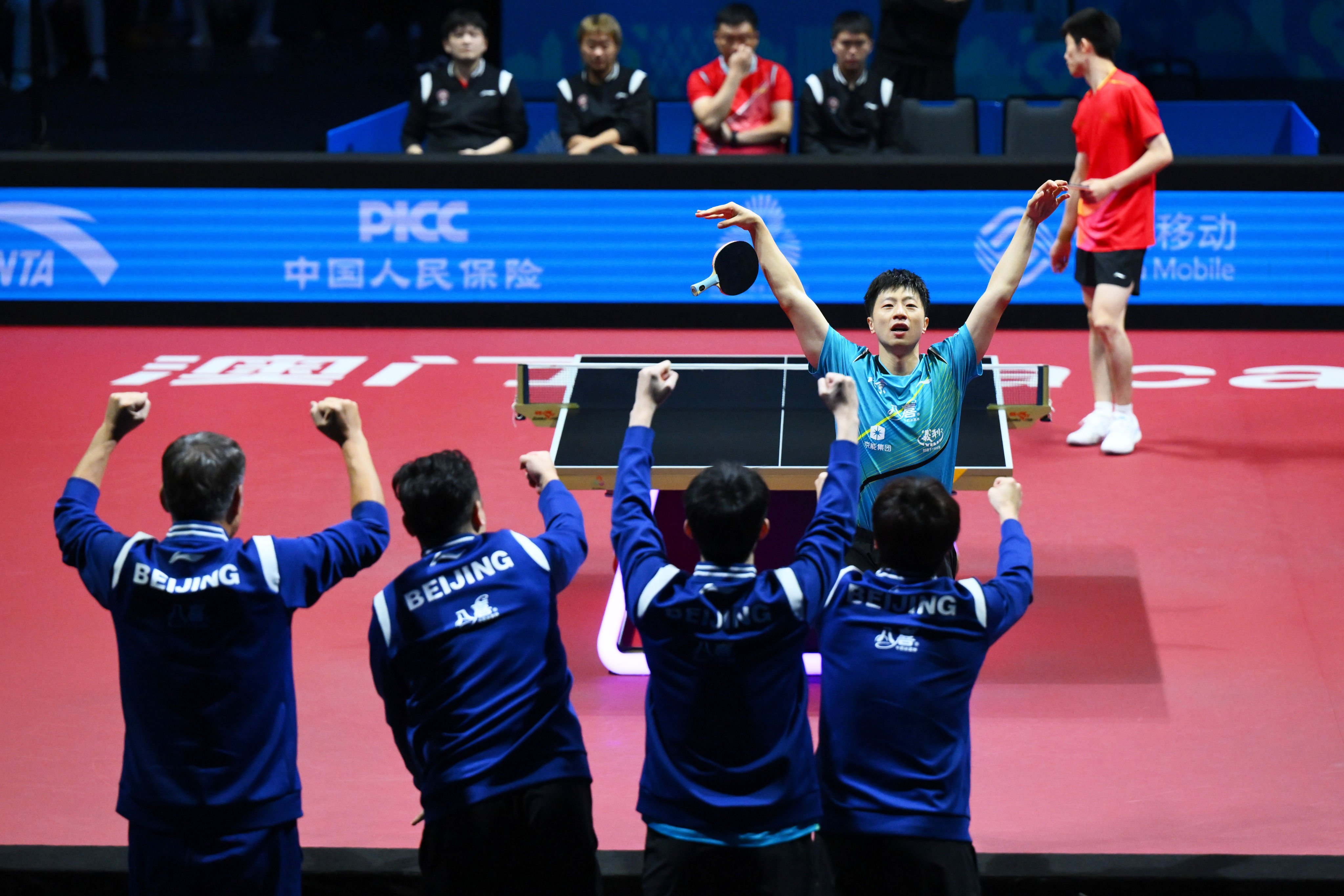 Ma Long of Beijing (middle right) celebrates his win over  Zhou Kai of Shanghai, giving his team a 2-1 lead in the men’s team final at the National Games in Macau on Thursday. Photo: Xinhua
