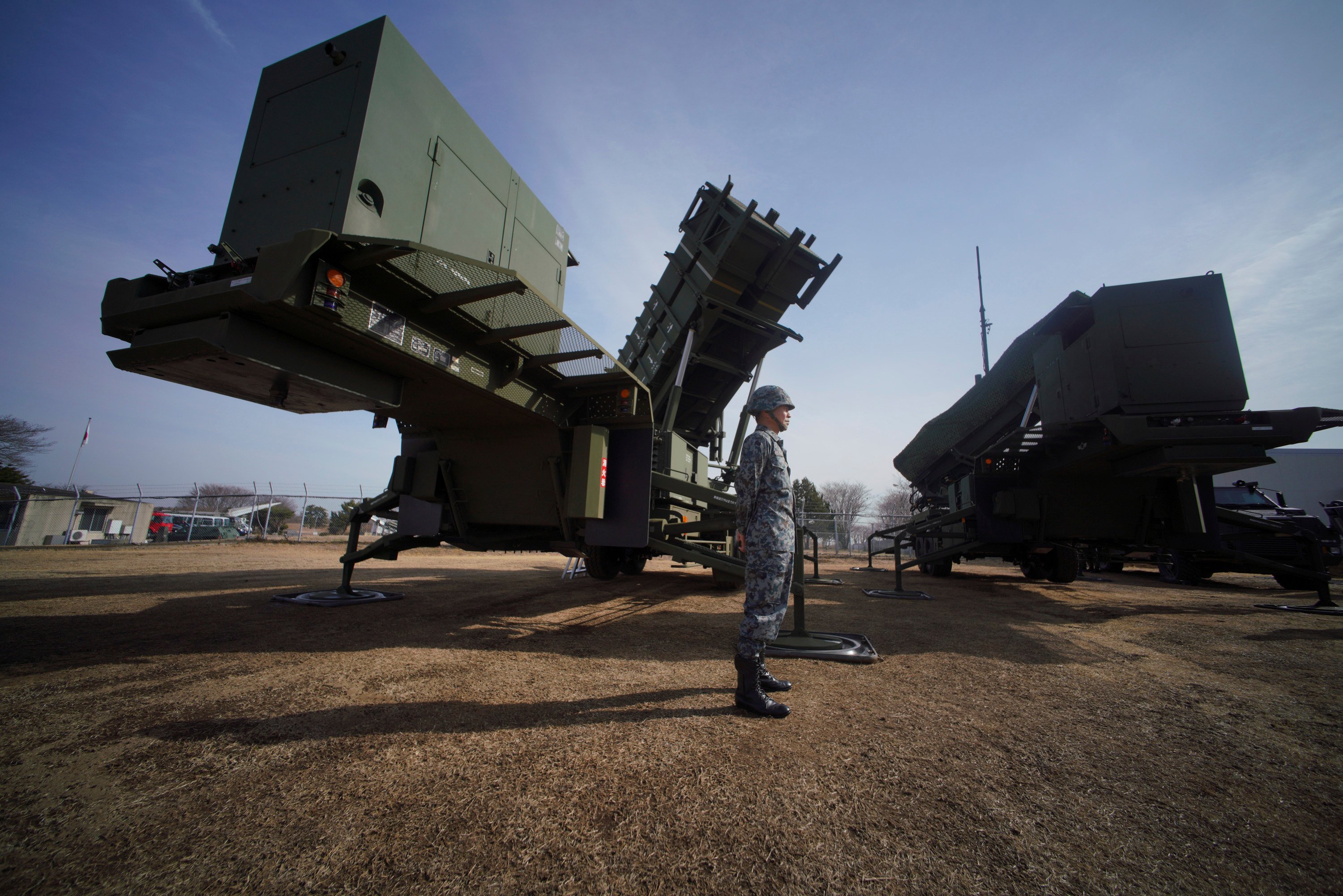 A member of the Japan Ground Self-Defence Force stands guard next to a surface-to-air Patriot Advanced Capability-3 missile interceptor launcher vehicle in Funabashi, east of Tokyo, on January 18, 2018. Photo: AP