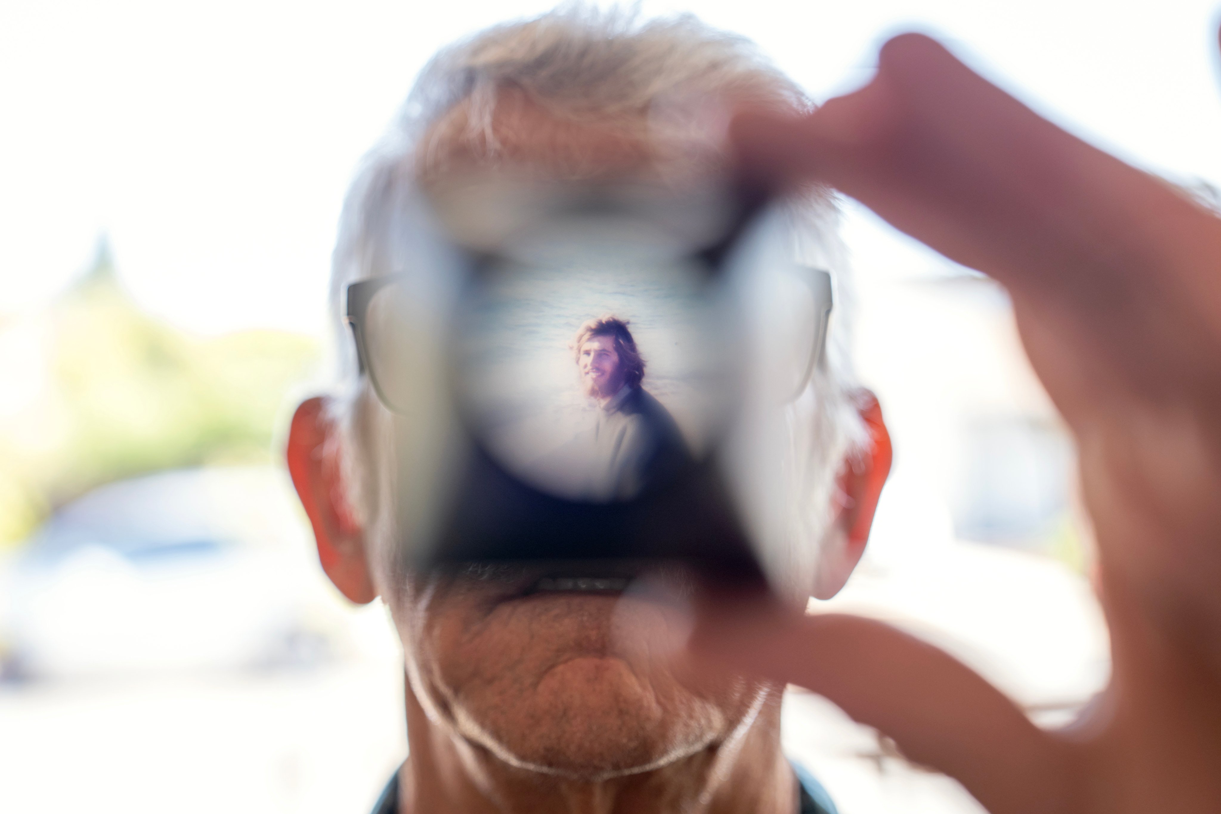 Christy Morrill holds up a viewfinder with a slide film of himself as a young man. Autoimmune encephalitis left him unable to remember years of his life, and can leave sufferers in hospital, but treatments are in development. Photo: AP