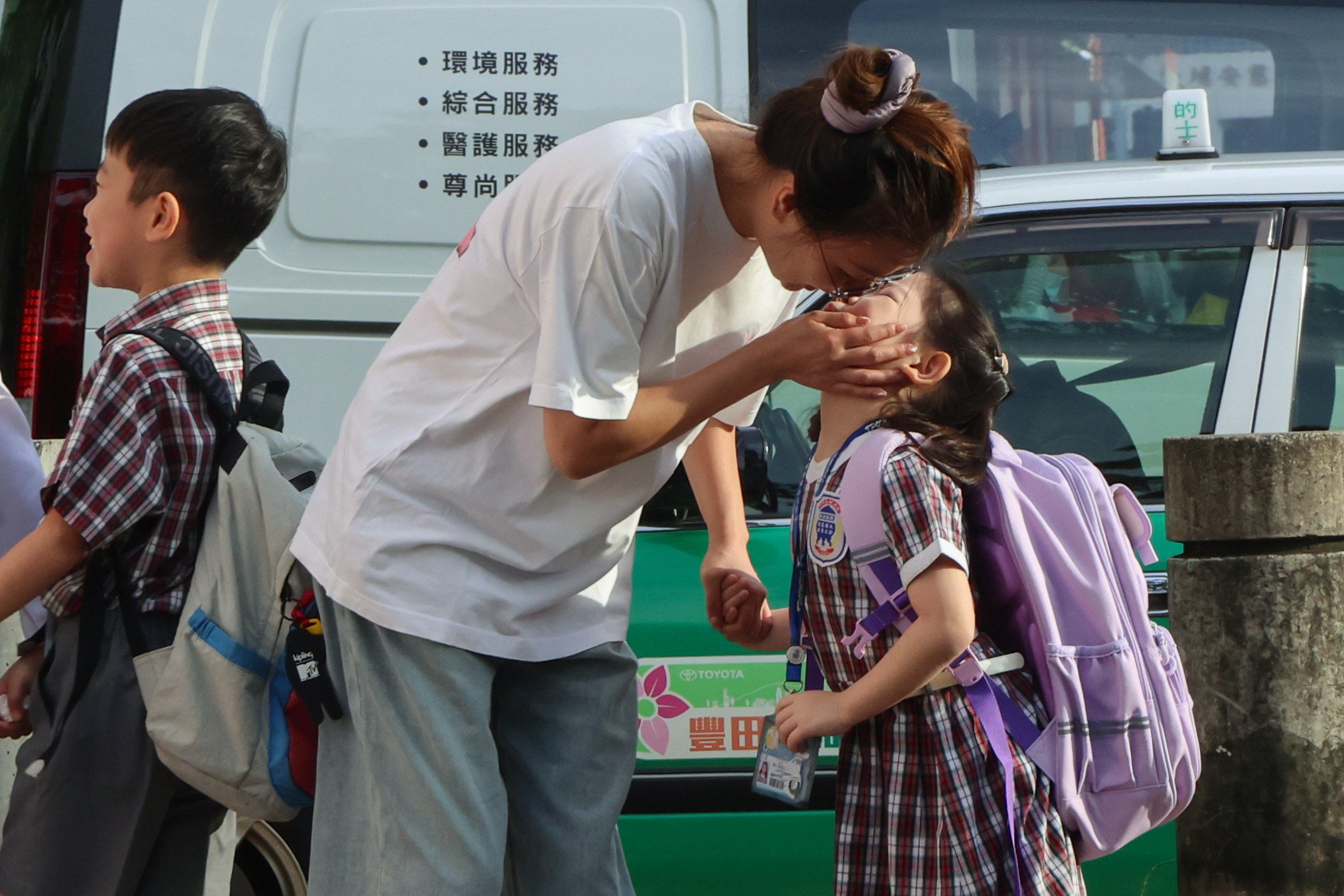 A student from a primary school in Tai Po gets a warm send-off to school, on the first day of the school year on September 1. Children learn best when their emotional needs are met. Photo: Jelly Tse