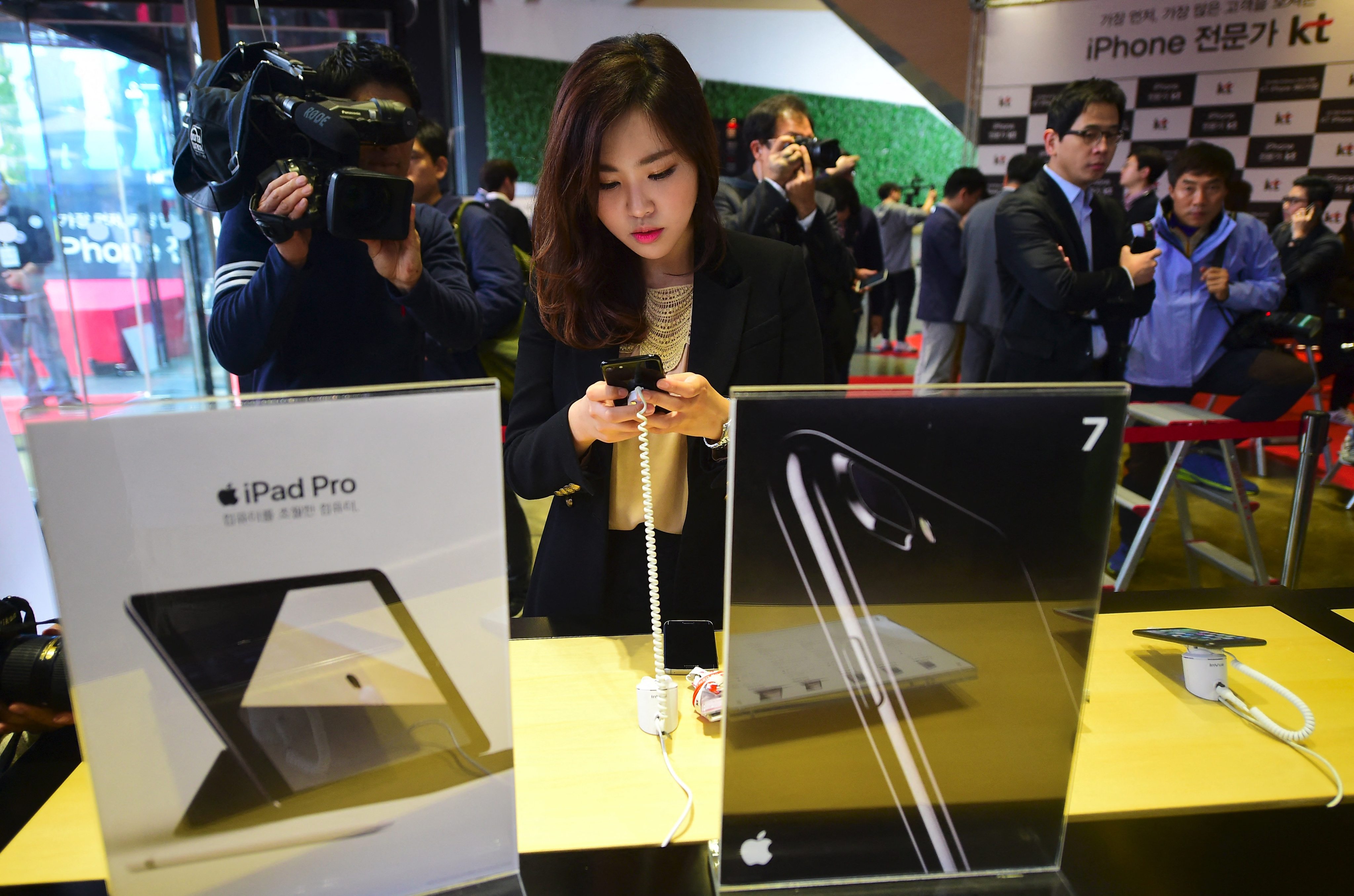 A woman looks at an Apple iPhone at a shop in Seoul. Photo: AFP