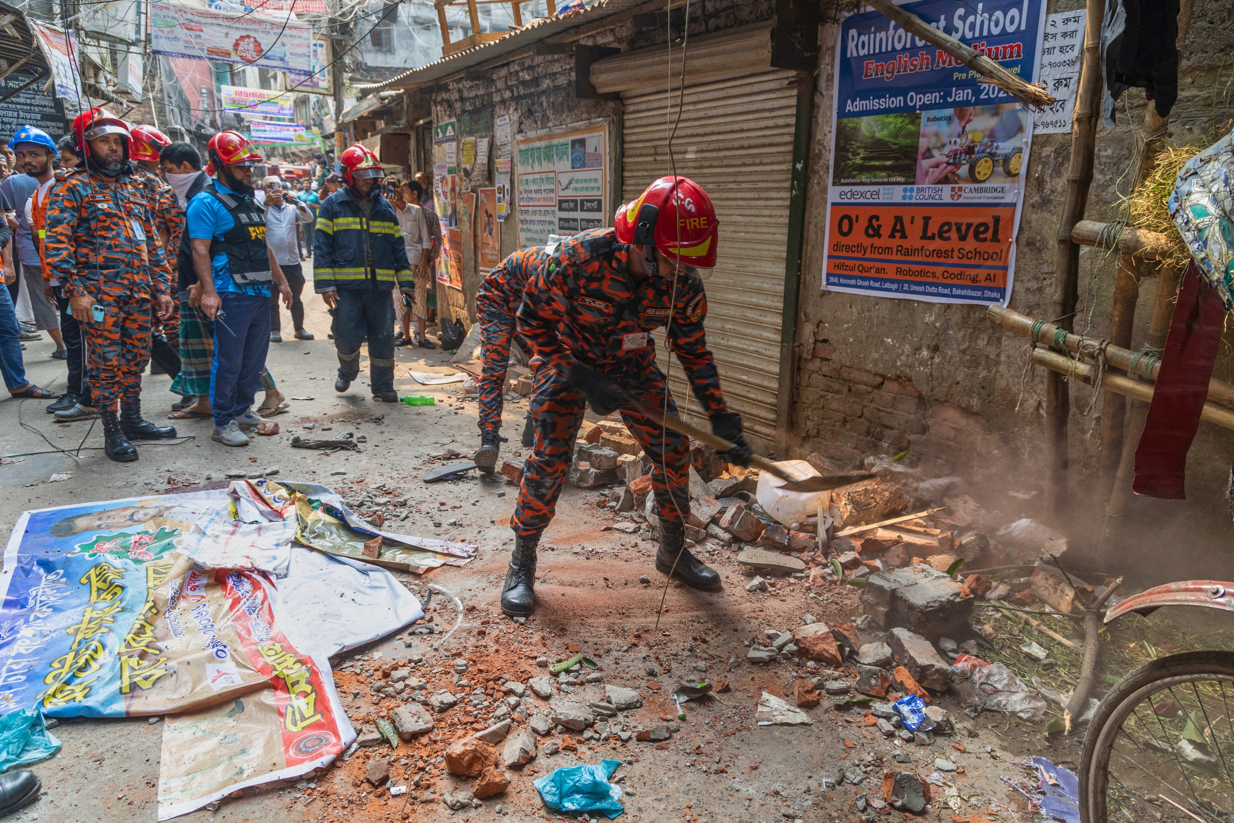 Rescuers clear debris from a roof and wall collapse after an earthquake in Dhaka, Bangladesh, on Friday. Photo: AP