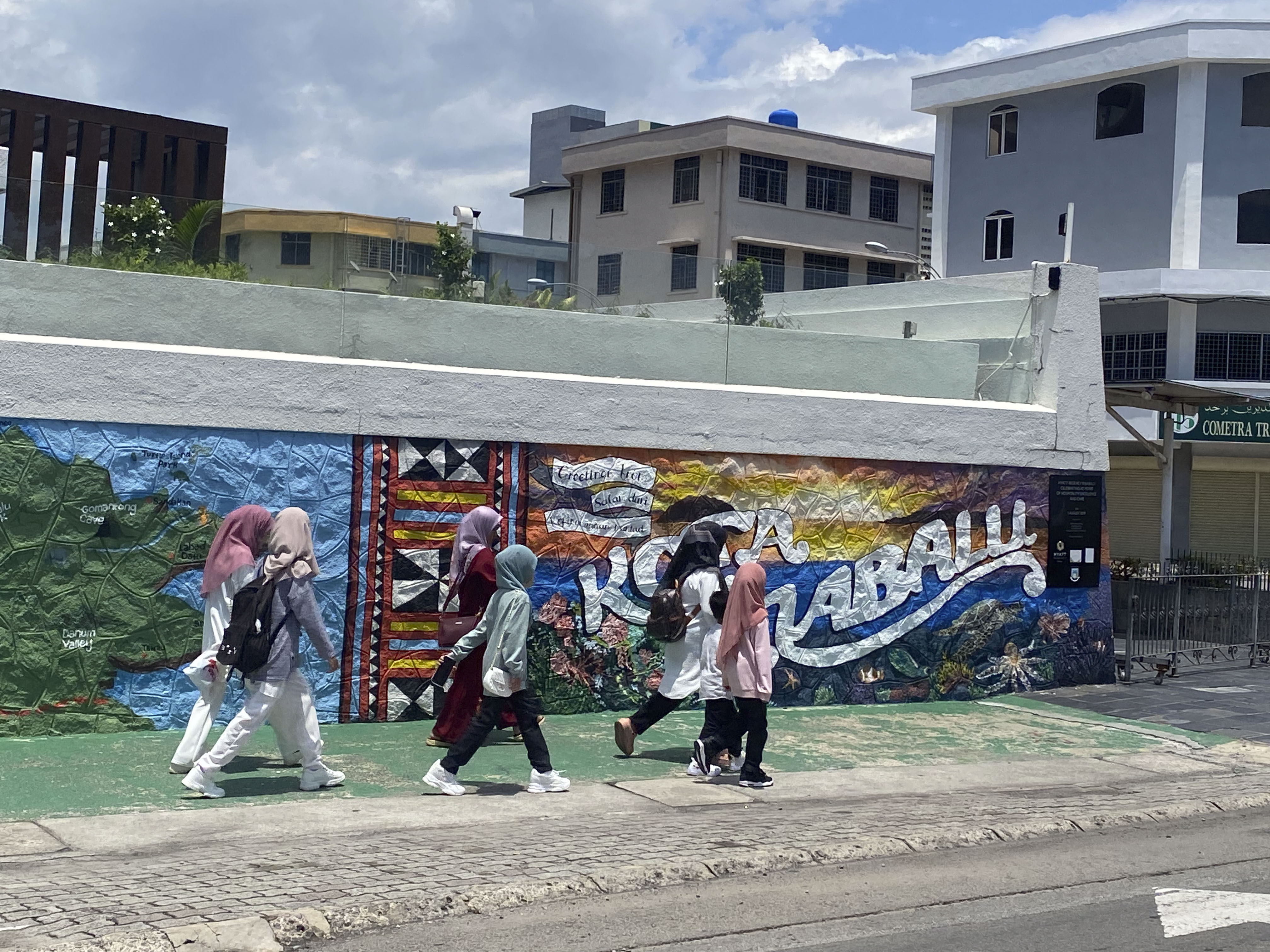 Young Malaysians walk along a street in Kota Kinabalu, Sabah, Malaysia. Photo: Tamara Hinson