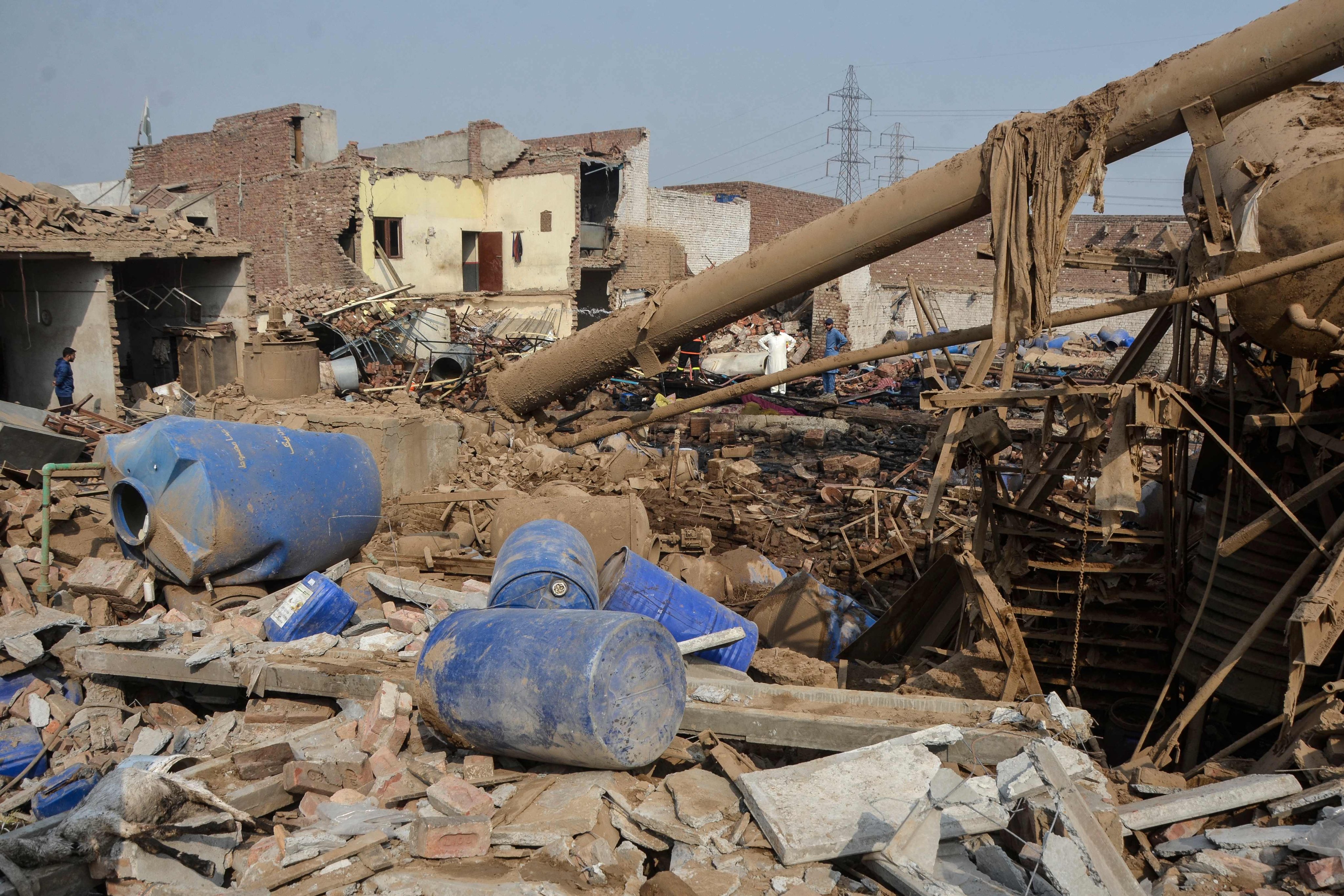 Rescuers search for survivors after an explosion at a glue-manufacturing factory in Faisalabad on Friday. Photo: AFP