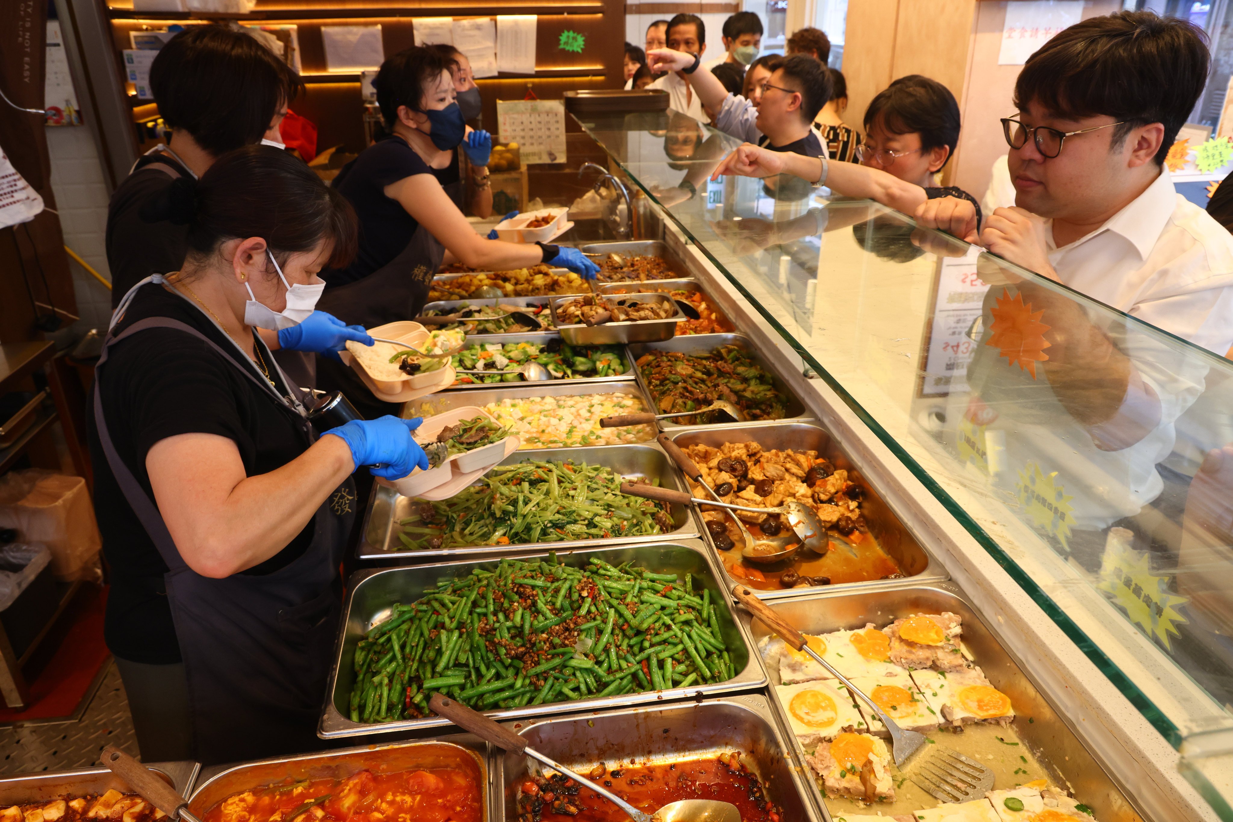 People place their orders at a two-dish rice shop in Causeway Bay on July 17. Photo: Dickson Lee