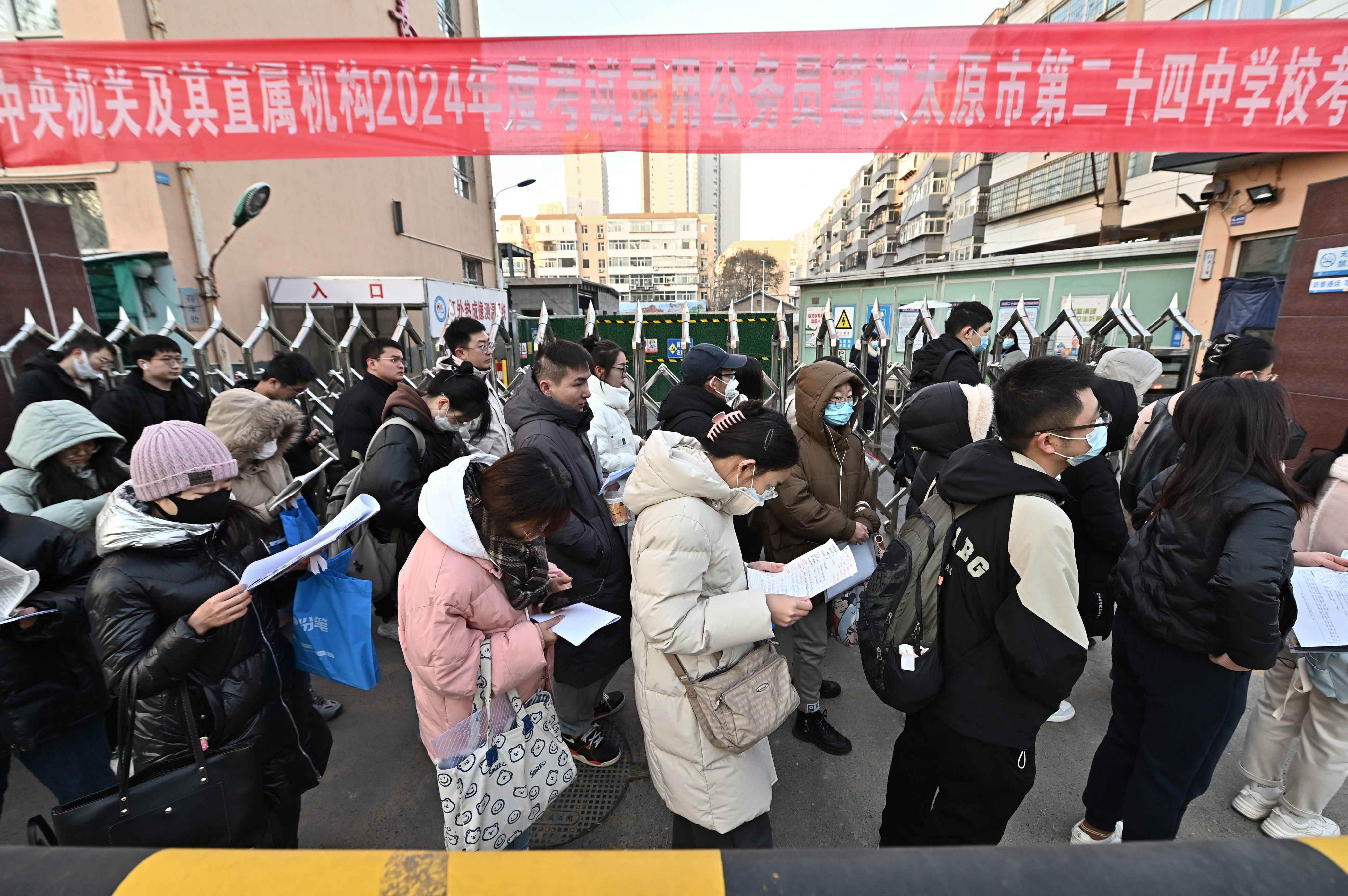 Candidates for the civil service exam wait outside a testing centre in central China. The “iron rice bowl” jobs are highly prized. Photo: Getty Images