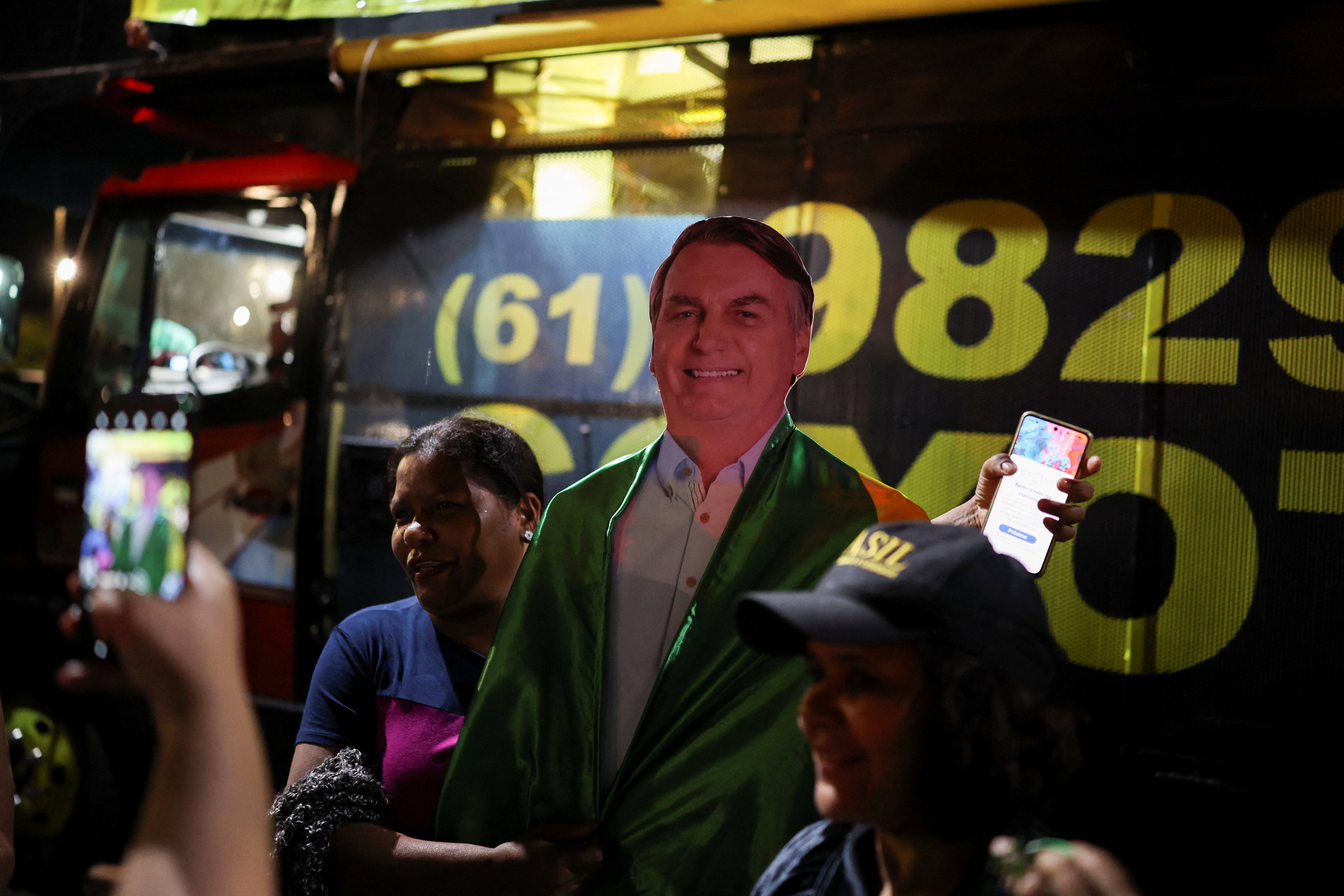 A person holds a cut-out of Brazil’s former president Jair Bolsonaro during a vigil in Brasilia on Saturday. Photo: Reuters