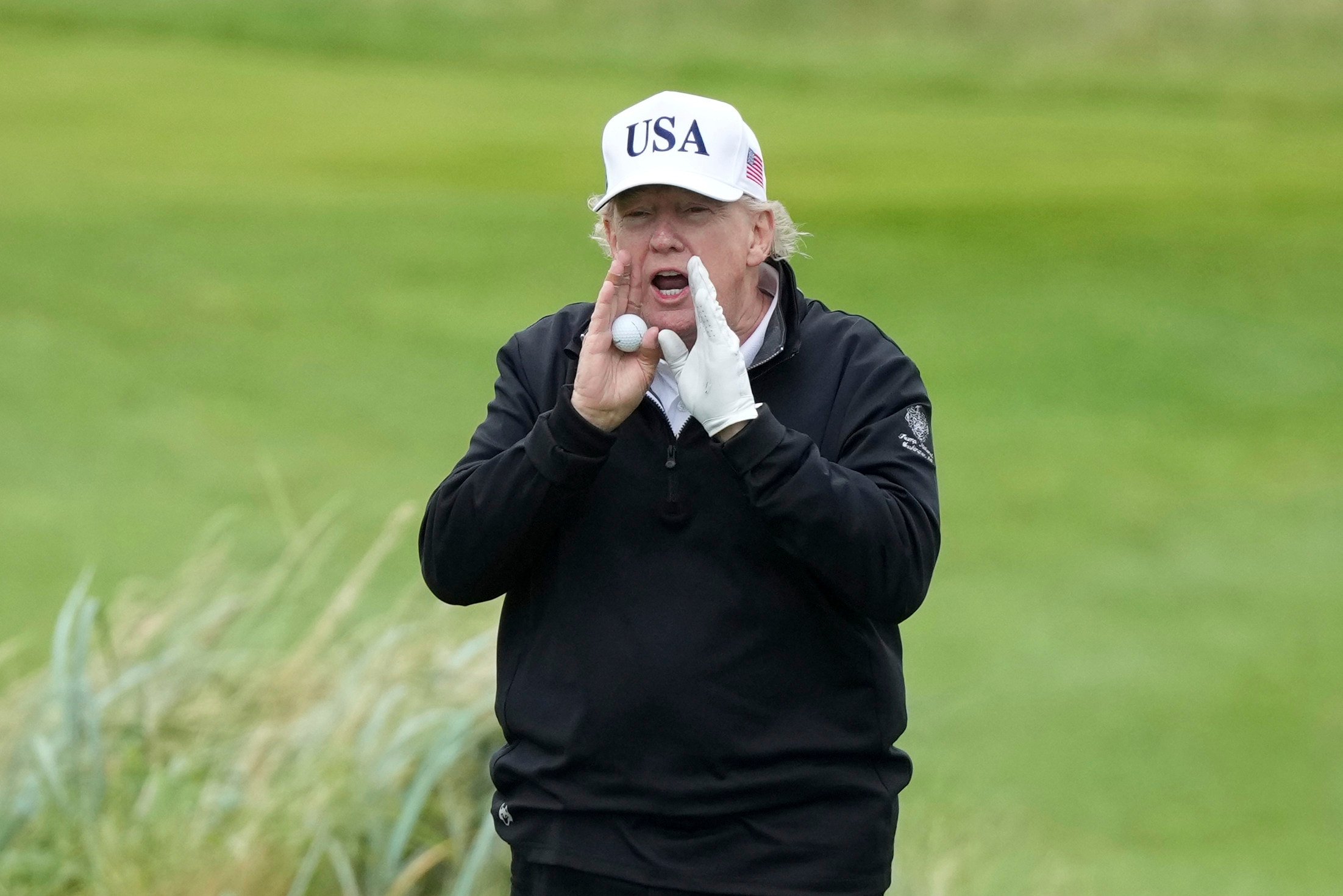 US President Donald Trump shouts as he plays golf at the Trump Turnberry golf course in Scotland in July. Photo: AP