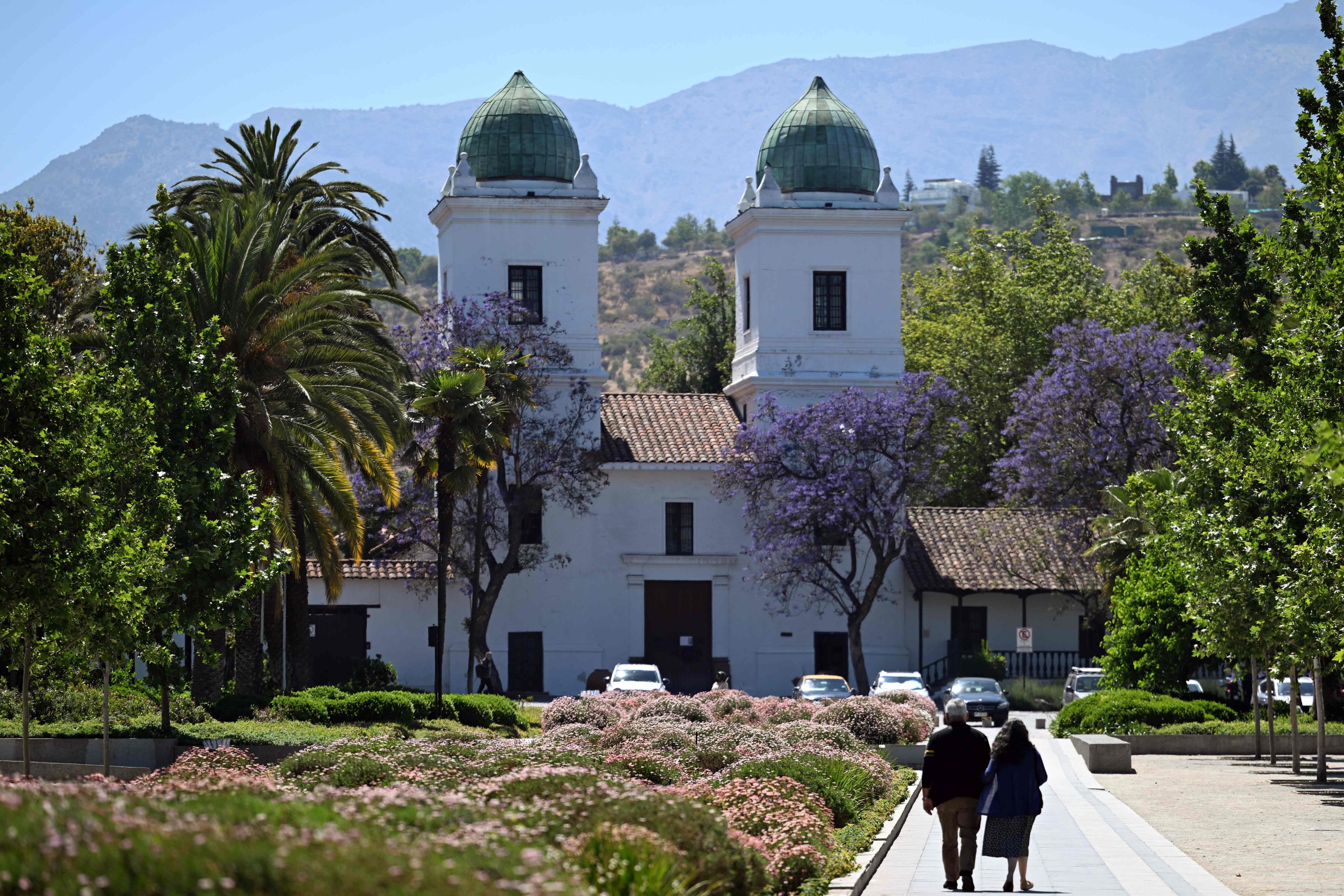 People walk near a church in the commune of Las Condes, in Santiago, Chile on November 12. Photo: AFP