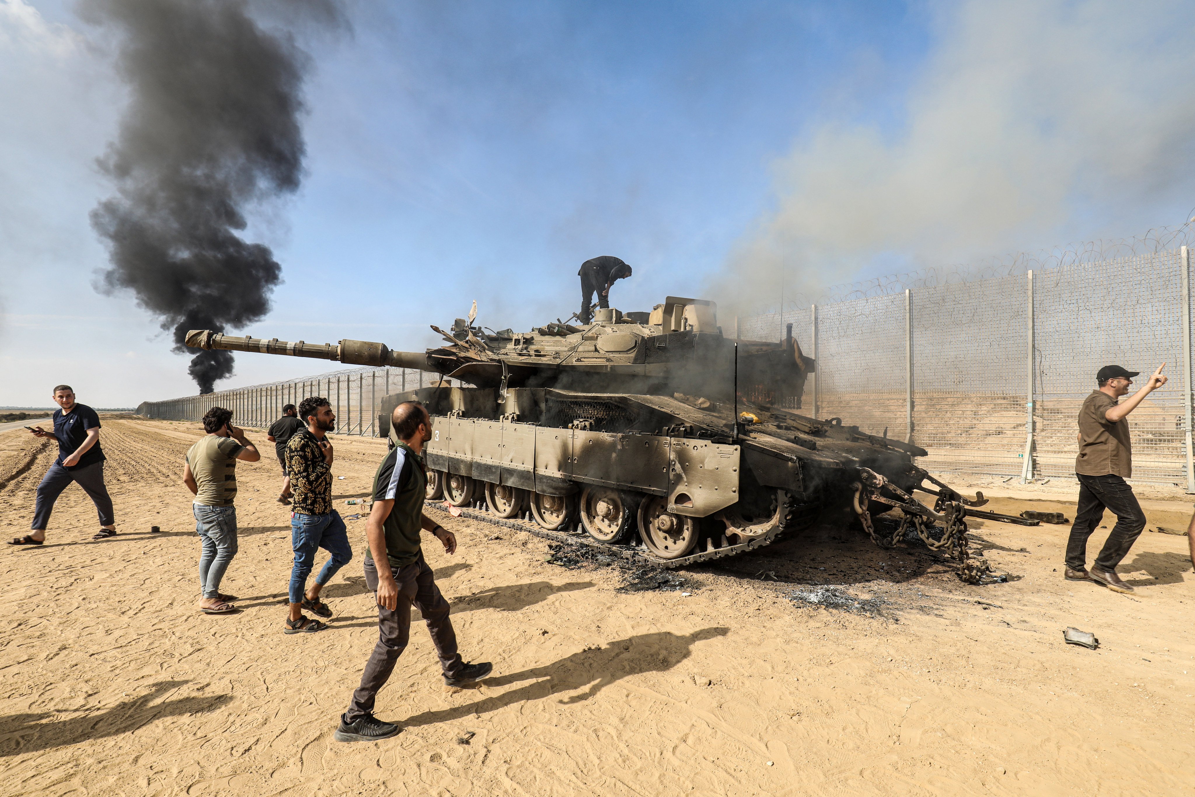 Palestinians take control of an Israeli tank after crossing the border fence with Israel from Khan Younis on October 7, 2023. Photo: dpa